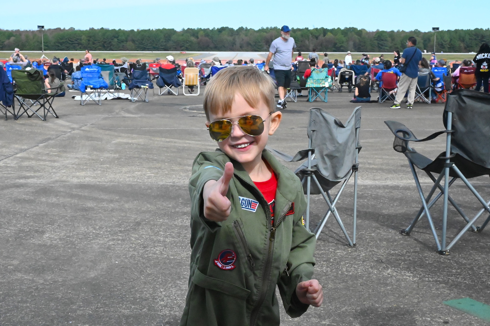 Little boy posing in flight suit