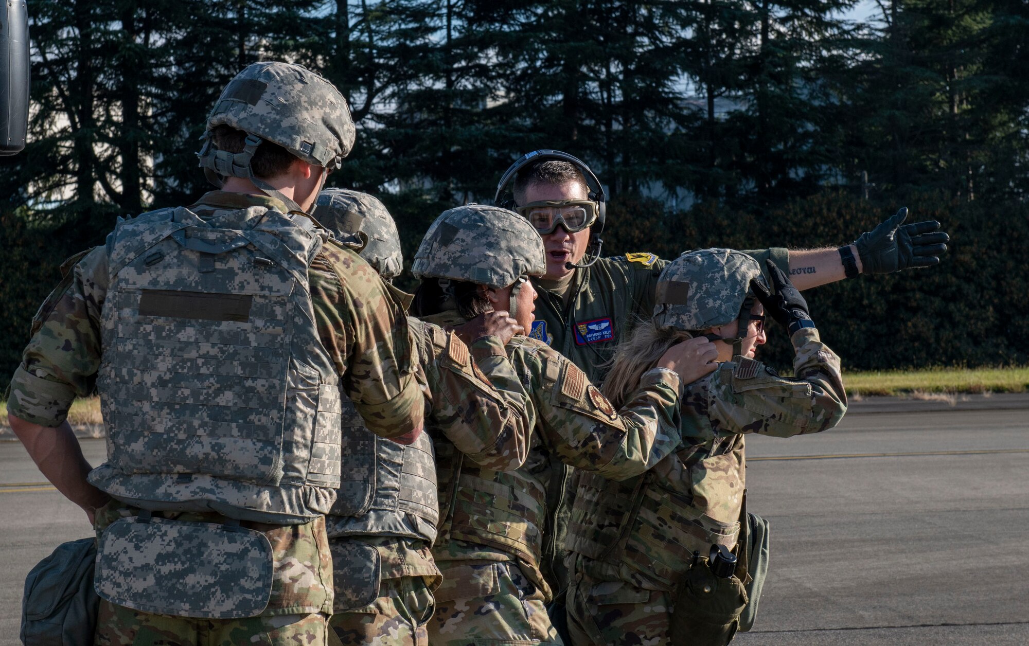 An officer directs medical personnel toward an aircraft