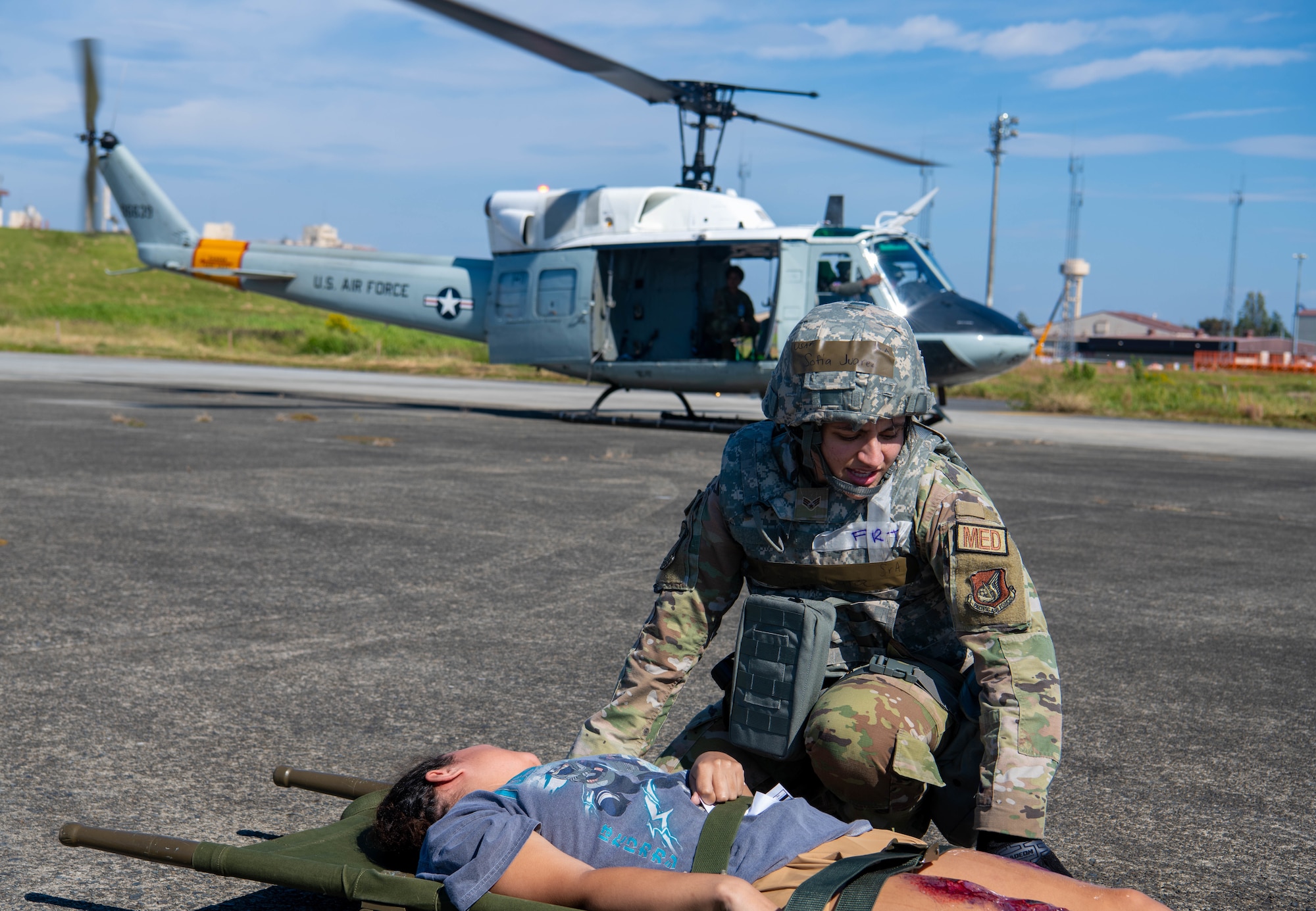 An Airman gives aid to a simulated patient