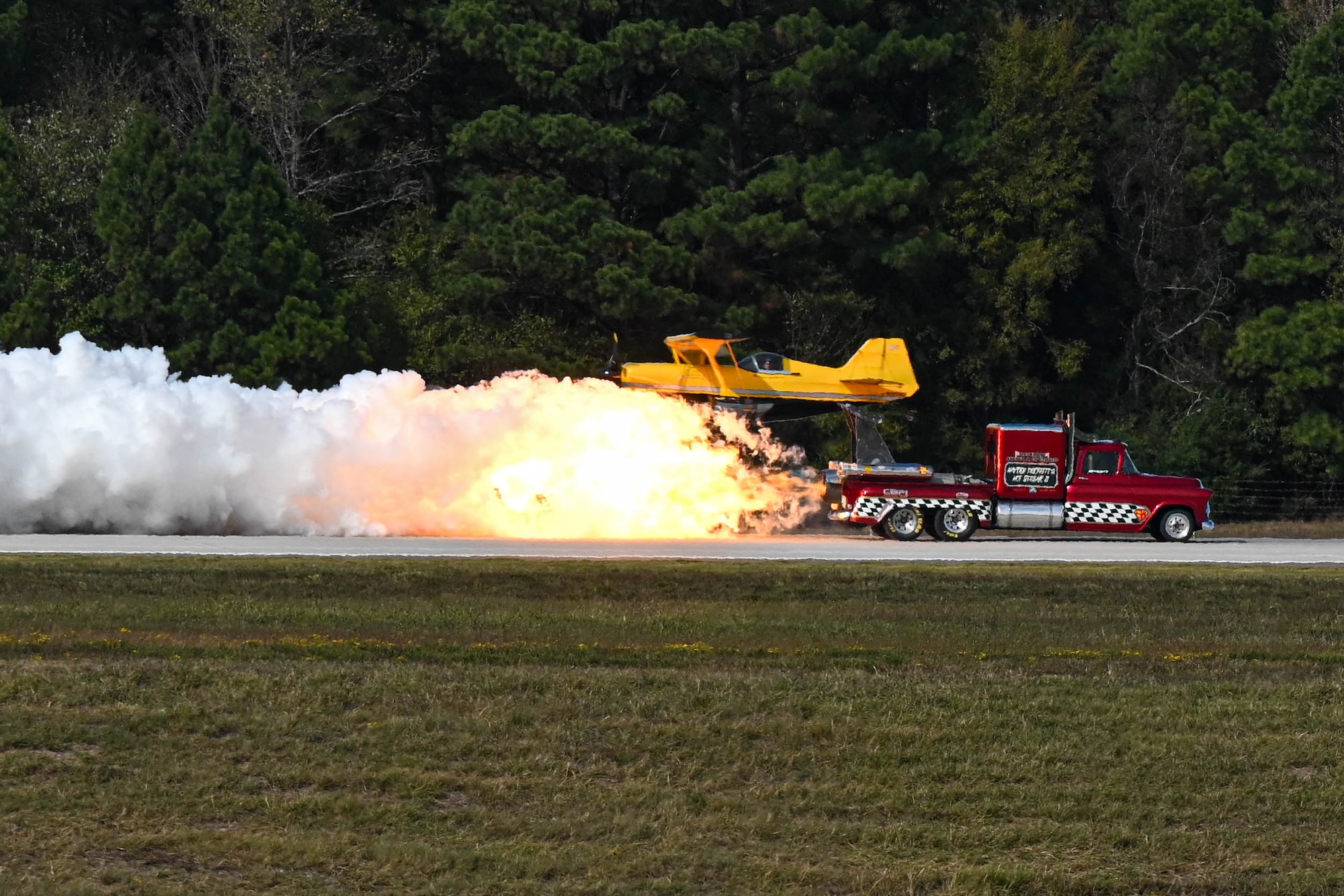Fire truck with jet engines on runway.