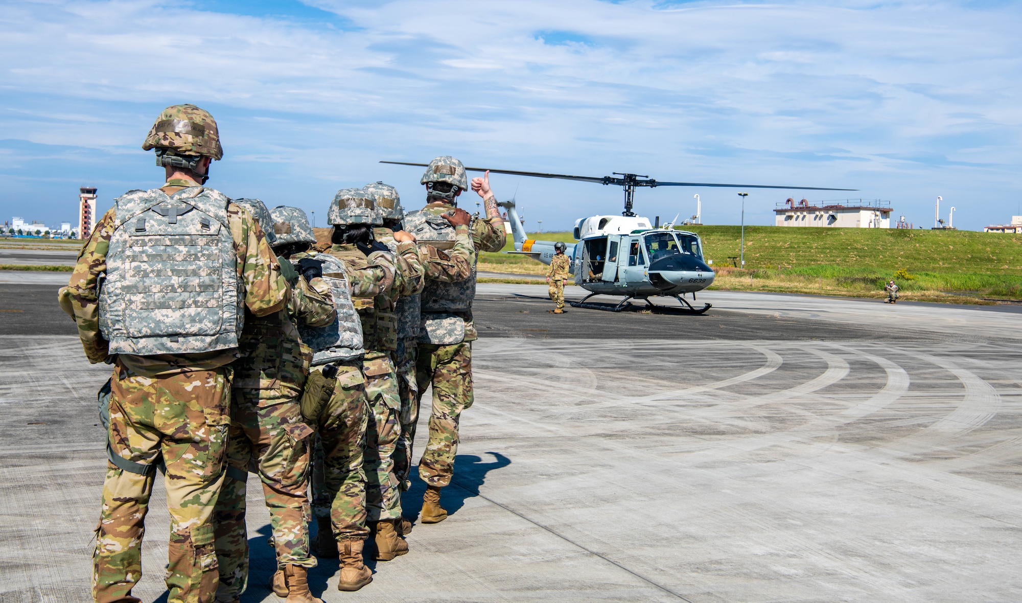 Airmen from the 374th Medical Group receive simulated patients from a helicopter