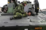 Army Gen. Daniel Hokanson, chief of the National Guard Bureau, talks with a Swedish Armed Forces officer from the driver's seat of a CV9040, Boden, Sweden, Oct. 17, 2023. Hokanson visited Sweden as part of a larger Northern European itinerary for talks with defense officials to deepen bilateral ties between the National Guard and Sweden.