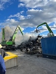 Commercial salvage excavators work to overhaul scrap metal that caught fire aboard a barge in the Newark Harbor on Oct. 22 2023. Coast Guard pollution responders supervise the operation to limit the opportunity of pollution entering the water. (Photo courtesy of Ken's Marine)