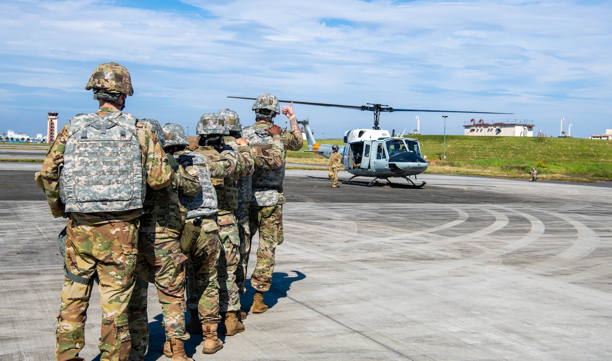 Airmen from the 374th Medical Group receive simulated patients from a helicopter