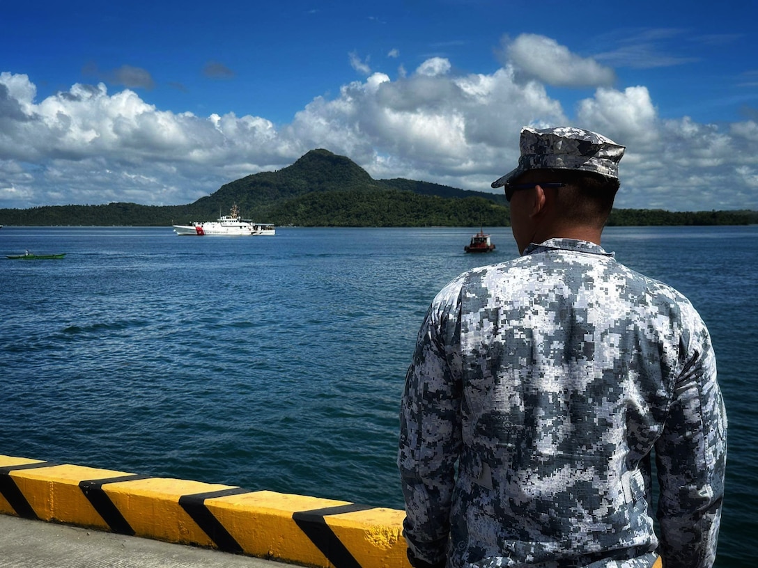Colleagues from the Philippine Coast Guard prepare to receive the crew of the USCGC Frederick Hatch (WPC 1143) at the pier in Tacloban, Philippines, on Oct. 19, 2023. In a historic first, the USCGC Frederick Hatch (WPC 1143) visited Tacloban, Philippines, from Oct. 19 to 23, 2023, and the crew conducted engagements marking a significant milestone in the enduring relationship between the United States and the Philippines. (U.S. Coast Guard photo by Cmdr. Ryan Crose)