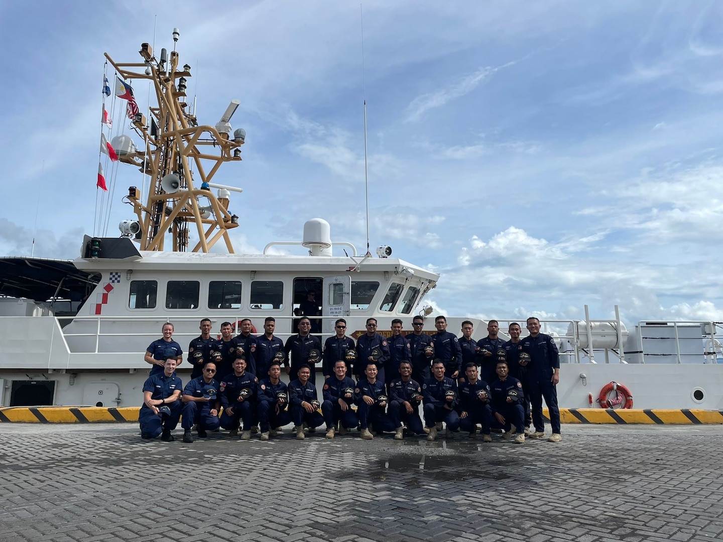 Members of USCGC Frederick Hatch (WPC 1143) stand for a photo with colleagues from the Philippine Coast Guard before departing from the pier in Tacloban, Philippines, on Oct. 23, 2023. In a historic first, the USCGC Frederick Hatch (WPC 1143) visited Tacloban, Philippines, from Oct. 19 to 23, 2023, and the crew conducted engagements marking a significant milestone in the enduring relationship between the United States and the Philippines. (U.S. Coast Guard photo by Lt. Anna Vacarro)
