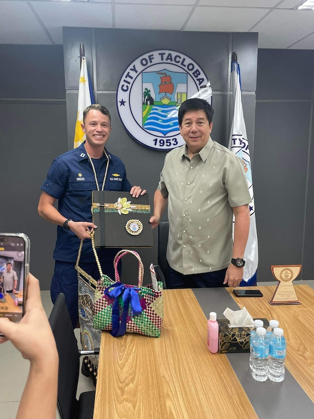 Lt. Patrick Dreiss, commanding officer of USCGC Frederick Hatch (WPC 1143), exchanges gifts with the Mayor of Tacloban City, Alfred Romualdez, in Tacloban, Philippines, on Oct. 20, 2023. In a historic first, the USCGC Frederick Hatch (WPC 1143) visited Tacloban, Philippines, from Oct. 19 to 23, 2023, and the crew conducted engagements marking a significant milestone in the enduring relationship between the United States and the Philippines. (U.S. Coast Guard photo by Lt. Anna Vaccaro)