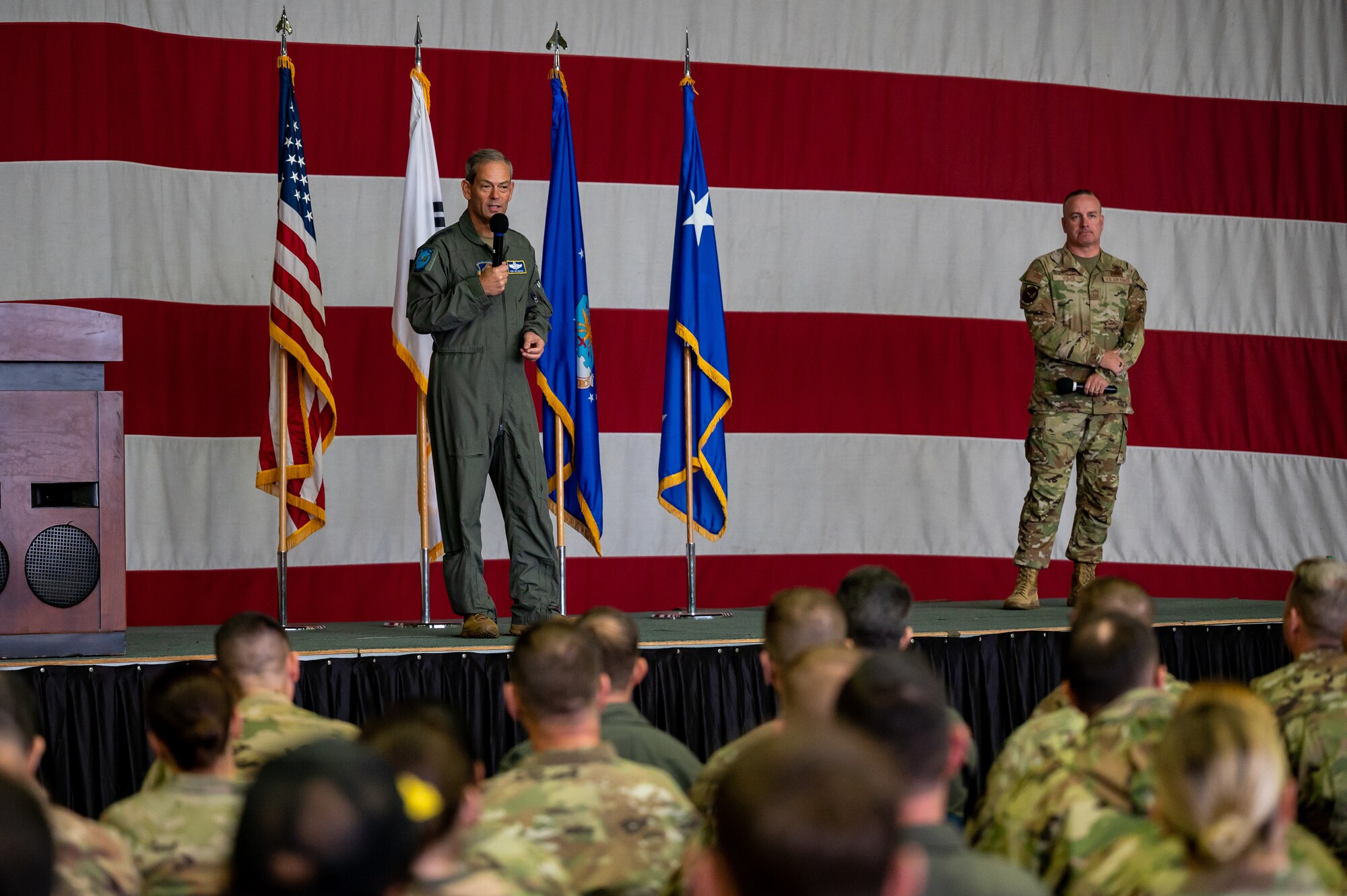 U.S. Air Force Gen. Ken Wilsbach, Pacific Air Forces commander, speaks during an all-call alongside Chief Master Sgt. David Wolfe, PACAF command chief, at Osan Air Base, Republic of Korea, Oct. 19, 2023.