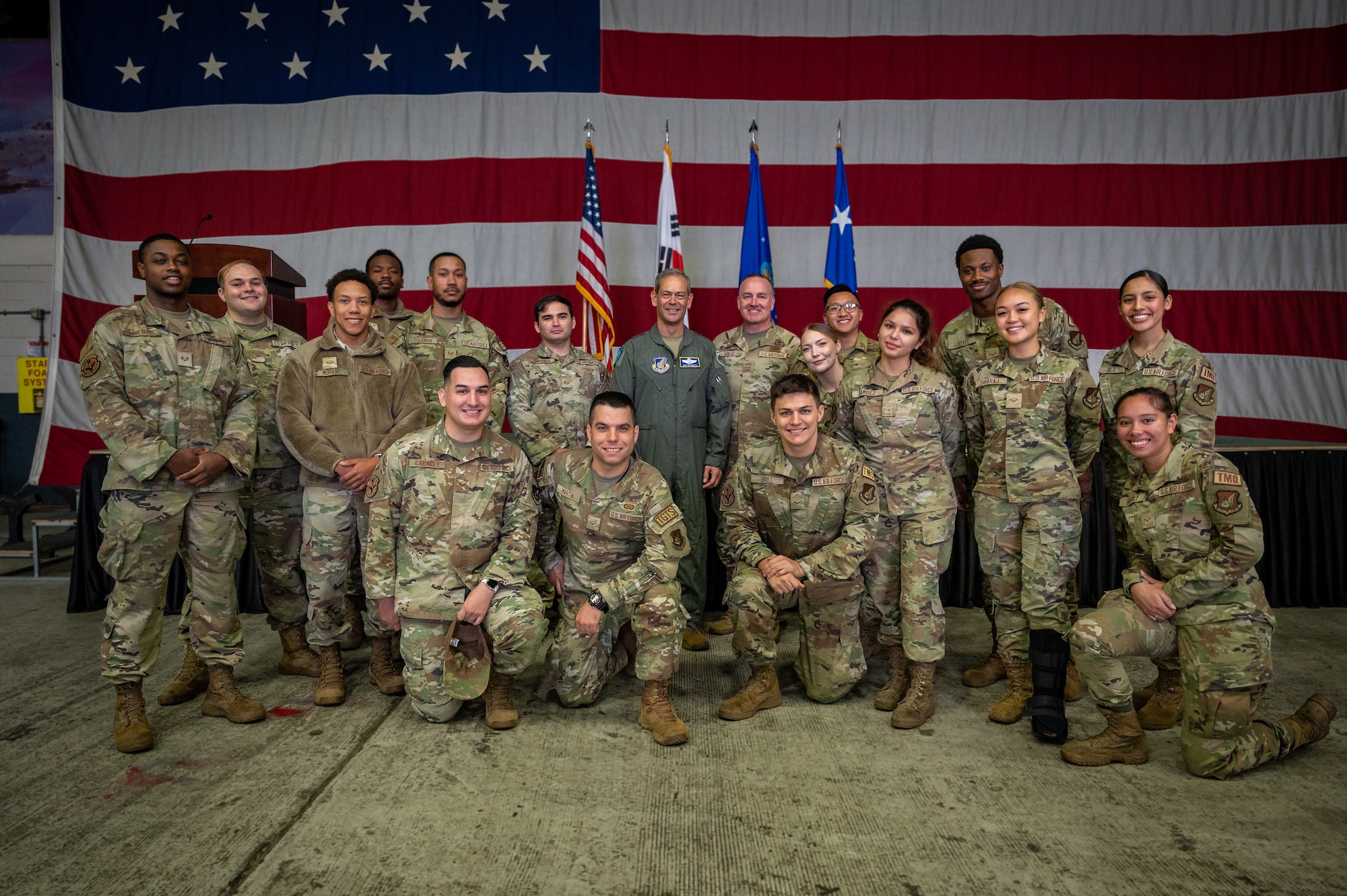 U.S. Air Force Gen. Ken Wilsbach, Pacific Air Forces commander, and Chief Master Sgt. David Wolfe, PACAF command chief, pose for a group photo with 51st Fighter Wing Airmen at Osan Air Base, Republic of Korea, Oct. 19, 2023.