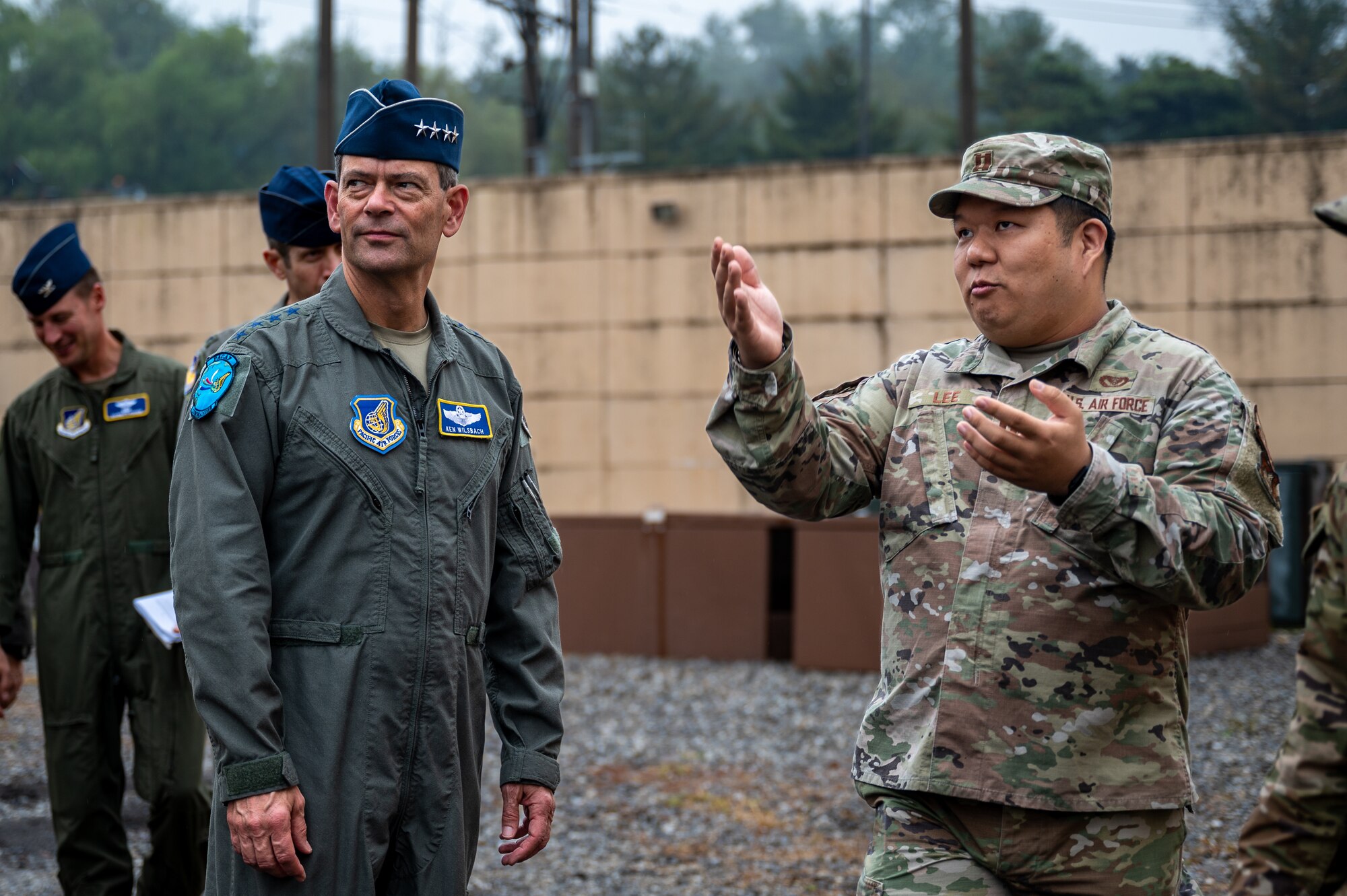 U.S. Air Force Gen. Ken Wilsbach, Pacific Air Forces commander, speaks with Capt. Kil Do Lee, 51st Civil Engineer Squadron chief of portfolio optimization, during a PACAF command team visit at Osan Air Base, Republic of Korea, Oct. 19, 2023.