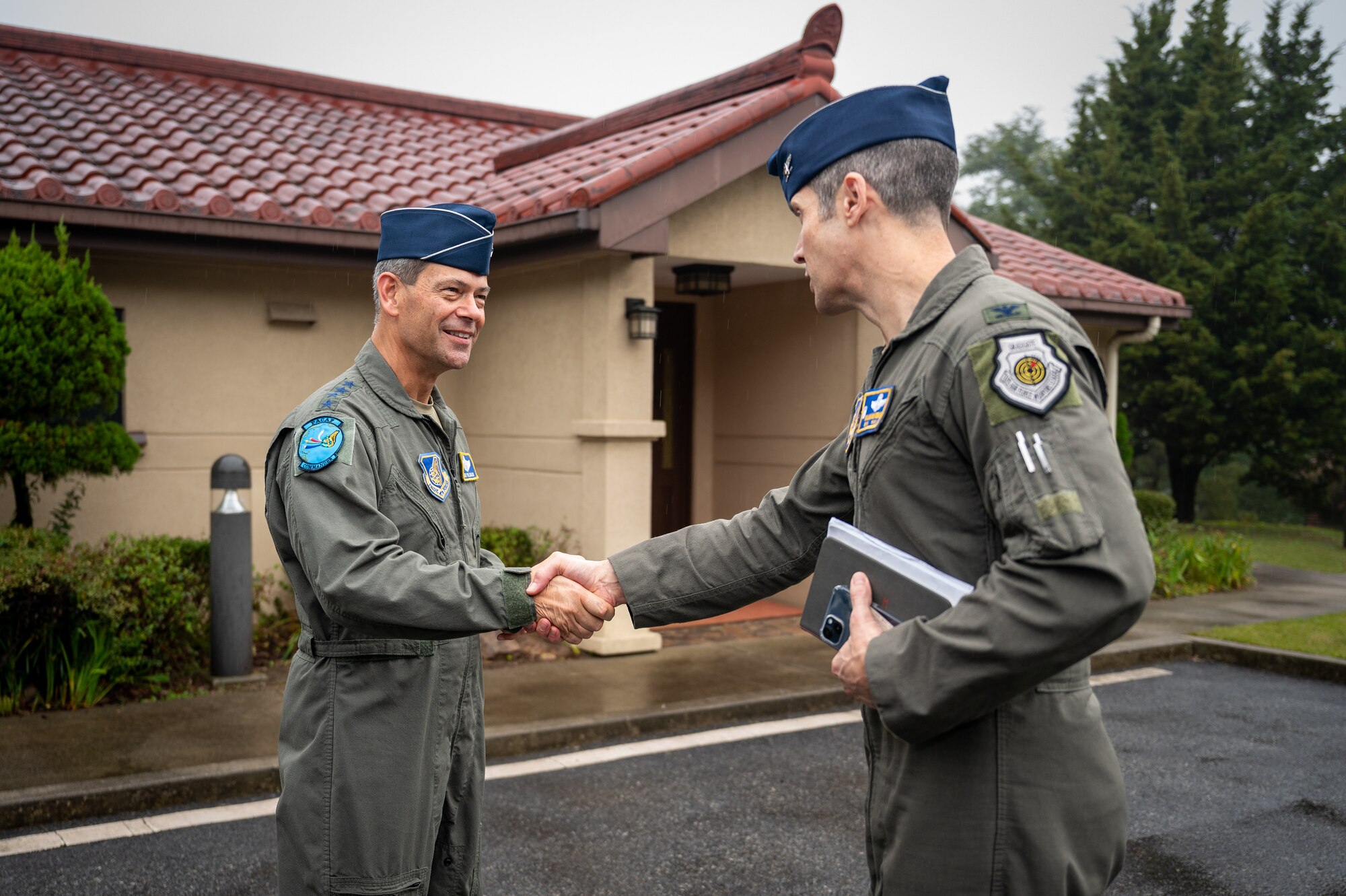 U.S. Air Force Gen. Ken Wilsbach, Pacific Air Forces commander, shakes hands with Col. William McKibban, 51st Fighter Wing commander, during a PACAF command team visit at Osan Air Base, Republic of Korea, Oct. 19, 2023.