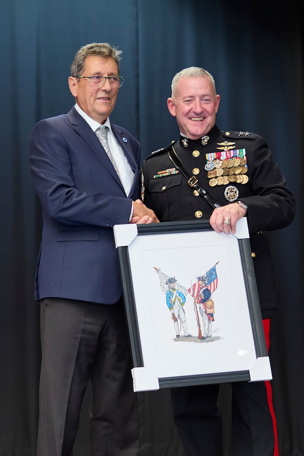 U.S. Marine Corps Maj. Gen. Robert B. Sofge Jr., commander of U.S. Marine Corps Forces Europe and Africa (MARFOREUR/AF), receives a gift from Daniel Geniteau, event organizer, during the Beirut bombing memorial in Lyon, France on Oct. 21, 2023. The Beirut bombing memorial commemorates the 40th anniversary of the attacks conducted against the French and Americans. This event occurs every five years, and notably, it’s the first time a U.S. Marine general has attended in a decade. Together, the French and U.S. Marines honor their comrades who served side by side in Lebanon in 1983, reinforcing the enduring bond between these two nations. (U.S. Marine Corps photo by Lance Cpl. Mary Linniman)