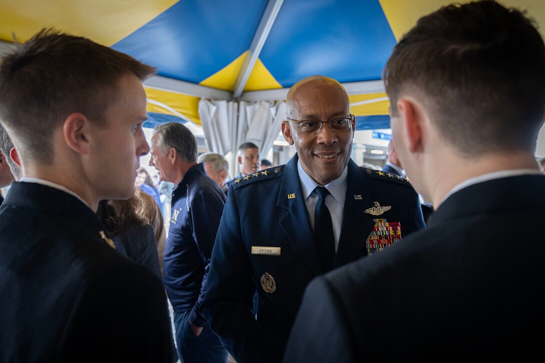 Air Force Gen. CQ Brown, Jr., chairman of the Joint Chiefs of Staff, speaks to troops outdoors under a tent.