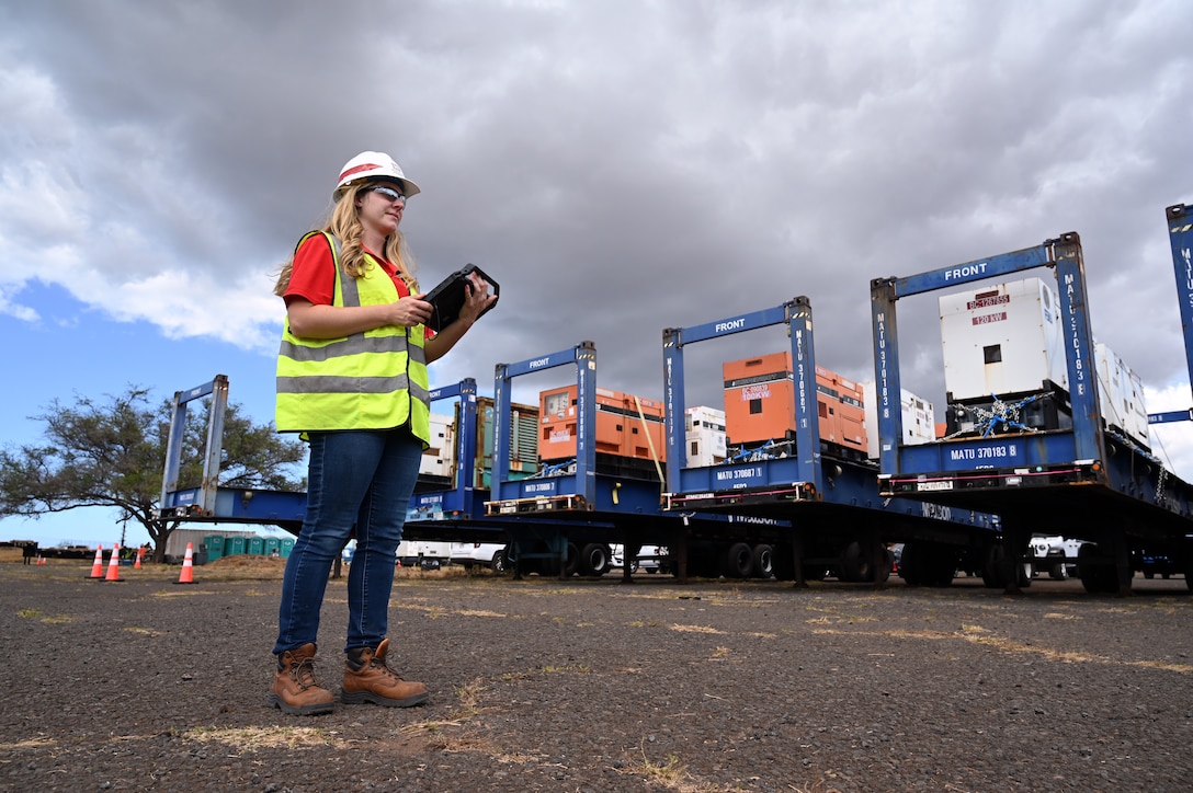 Jennifer Kist, U.S. Army Corps of Engineers, Charleston District geographer currently deployed to support recovery Hawaii Wildfire recovery efforts as a geographer, tracks generators with a tablet at a temporary work site in Kahului, Hawai’i, Aug. 25.