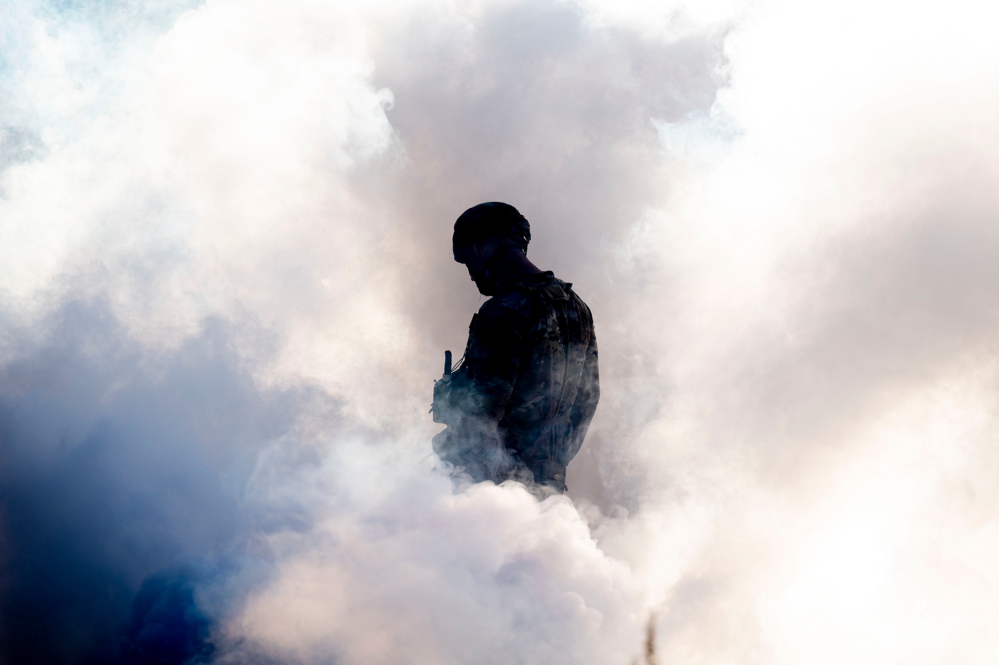 An Airman stands in smoke