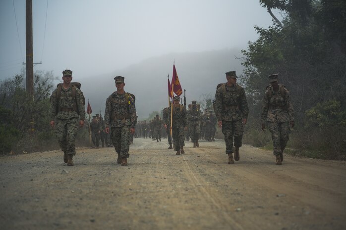 Hotel Company leadership, 2nd Recruit Training Battalion, march in front of a formation during the crucible hike at Marine Corps Base Camp Pendleton, California, Oct. 18, 2023. The crucible is a 54-hour exercise where recruits apply the knowledge, discipline and mental fortitude they learned throughout recruit training to earn the title of a United States Marine. (U.S. Marine Corps photo by Lance Cpl. Francisco Angel)