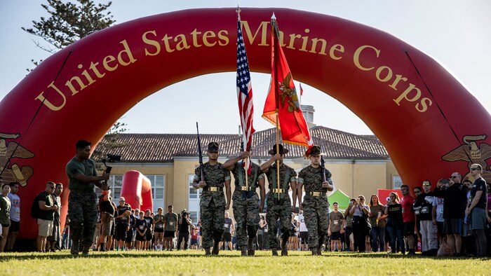 U.S. Marines with the Marine Corps Recruit Depot San Diego color guard, present the colors before the Boot Camp Challenge begins, Oct. 21, 2023. For the past 21 years the Boot Camp Challenge has offered a unique opportunity to the public to step into the shoes of a future Marine, guided by drill instructors to conquer a three-mile obstacle race and gain experience into what recruits go through during boot camp. (U.S. Marine Corps photo by Sgt. Yvonna Guyette)