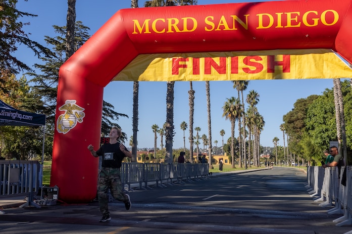 A participant of the Boot Camp Challenge crosses the finish line at Marine Corps Recruit Depot San Diego, Oct. 21, 2023. For the past 21 years the Boot Camp Challenge has offered a unique opportunity to the public to step into the shoes of a future Marine, guided by drill instructors to conquer a three-mile obstacle race and gain experience into what recruits go through during boot camp. (U.S. Marine Corps photo by Cpl. Alexander O. Devereux)