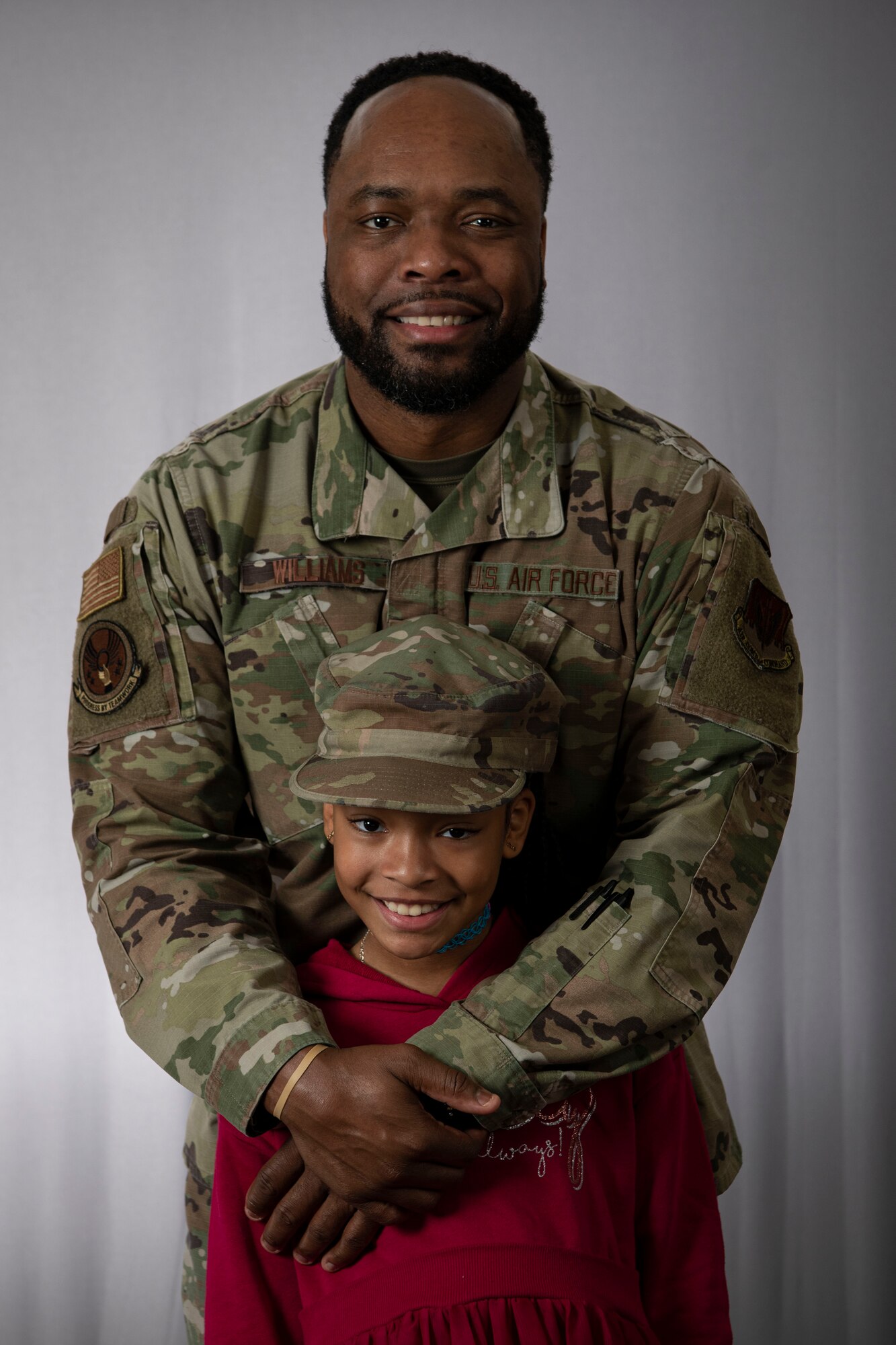 Air Force Tech. Sgt. Augustus Williams, 4th Fighter Wing drug demand reduction program manager, poses for a photo with his daughter, Alyssa, at Seymour Johnson Air Force Base, North Carolina, Jan. 4, 2022. Williams is a resilience trainer who is trained to aid other Airmen in developing resiliency skills, including mental, physical, social and spiritual health. (U.S. Air Force photo by Senior Airman Sabrina Fuller)