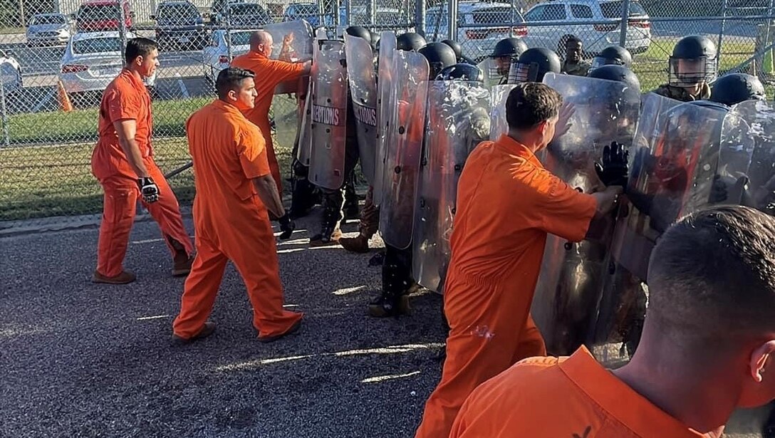Marines with the Corrections and Detention course train to have the skills required to operate a correctional or detention facility. Here they are conducting a culminating training evolution, quelling a prison riot.