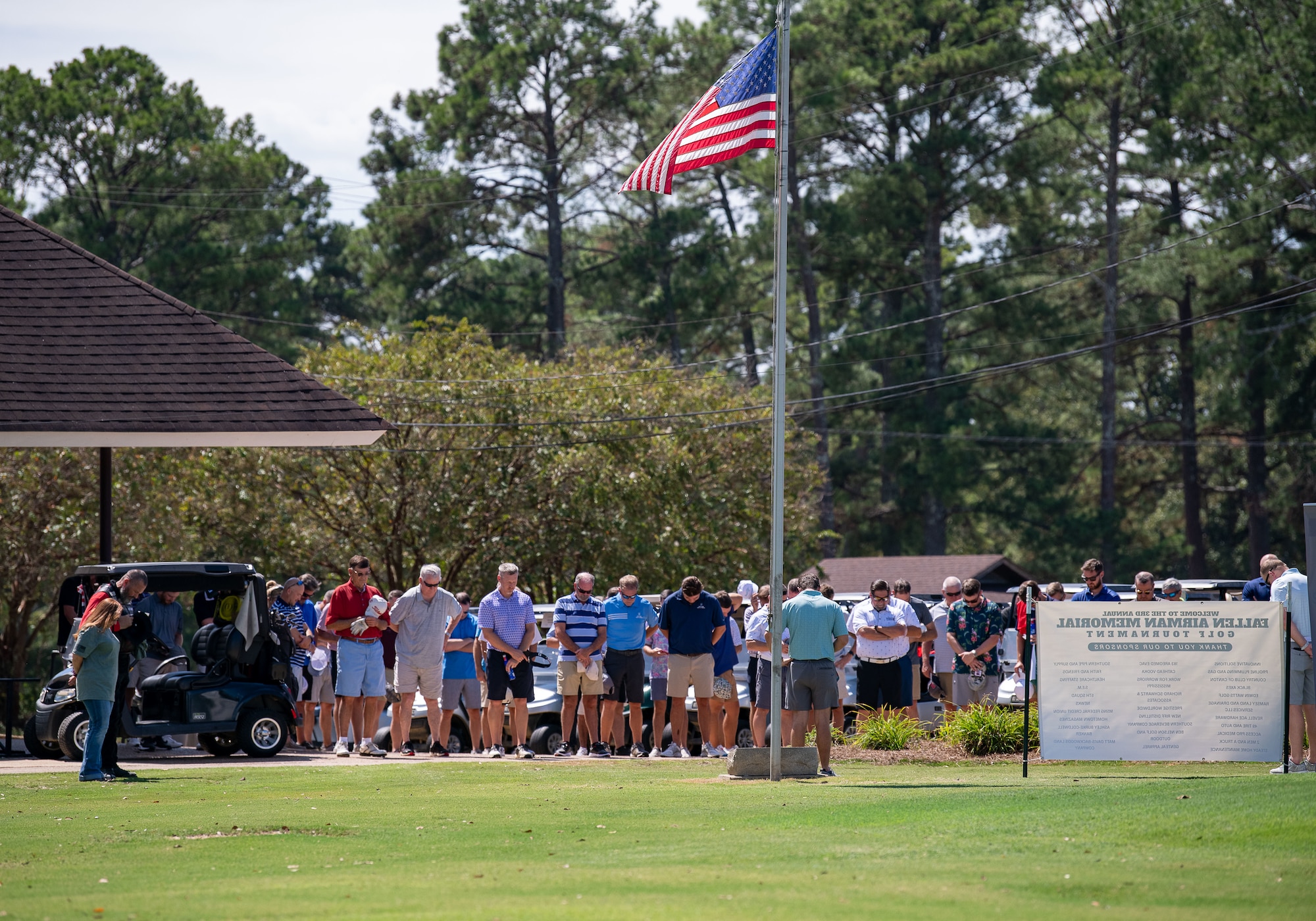 Participants of the third annual Fallen Airmen Memorial Golf Tournament at Canton Country Club, Canton, Mississippi, take a moment of silent reflection and gratitude on September 15, 2023. The FAM Golf Tournament is a servicemember-led initiative that benefits the 172nd AW Family Relief Fund, raising thousands of dollars for Air National Guard Families every year. (U.S. Air National Guard photo by Staff Sgt. Jared Bounds.)