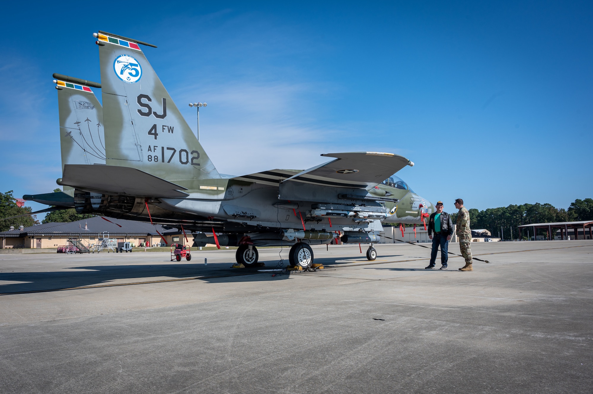 Capt. Timothy Chlasta (right), 334th Fighter Generation Squadron director of operations, showcases an F-15E Strike Eagle to retired Lt. Col. Clyde Stuhr during an event in recognition of the Battle of Britain at Seymour Johnson Air Force Base, North Carolina, Oct. 20, 2023. The Battle of Britain event highlighted all the fighter generation squadrons' history and present day accomplishments. (U.S. Air Force photo by Senior Airman Sabrina Fuller)