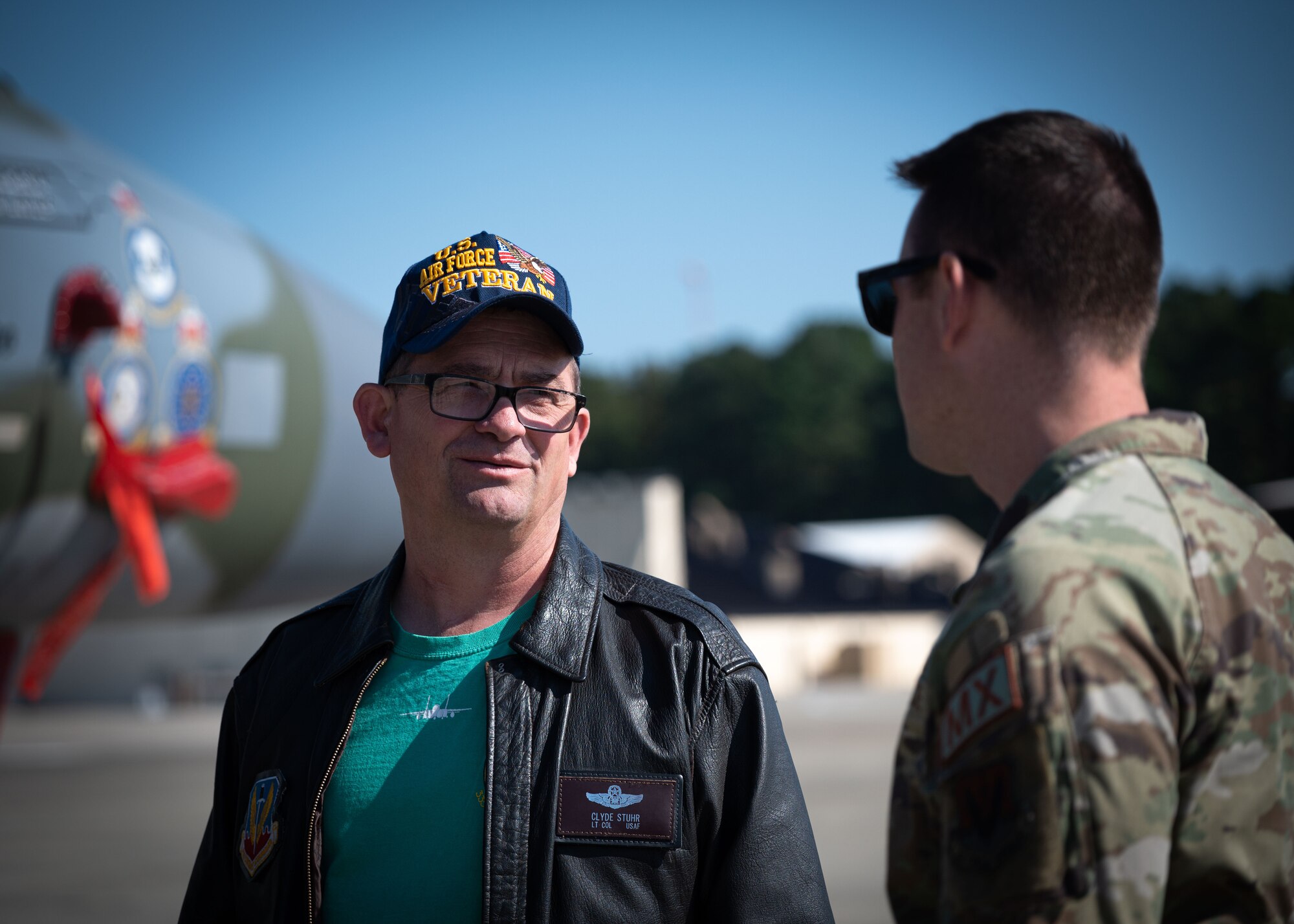 Capt. Timothy Chlasta (right), 334th Fighter Generation Squadron director of operations, showcases an F-15E Strike Eagle to retired Lt. Col. Clyde Stuhr during an event in recognition of the Battle of Britain at Seymour Johnson Air Force Base, North Carolina, Oct. 20, 2023. Stuhr shared about his time in the service as a pilot stationed at Seymour Johnson AFB. (U.S. Air Force photo by Senior Airman Sabrina Fuller)
