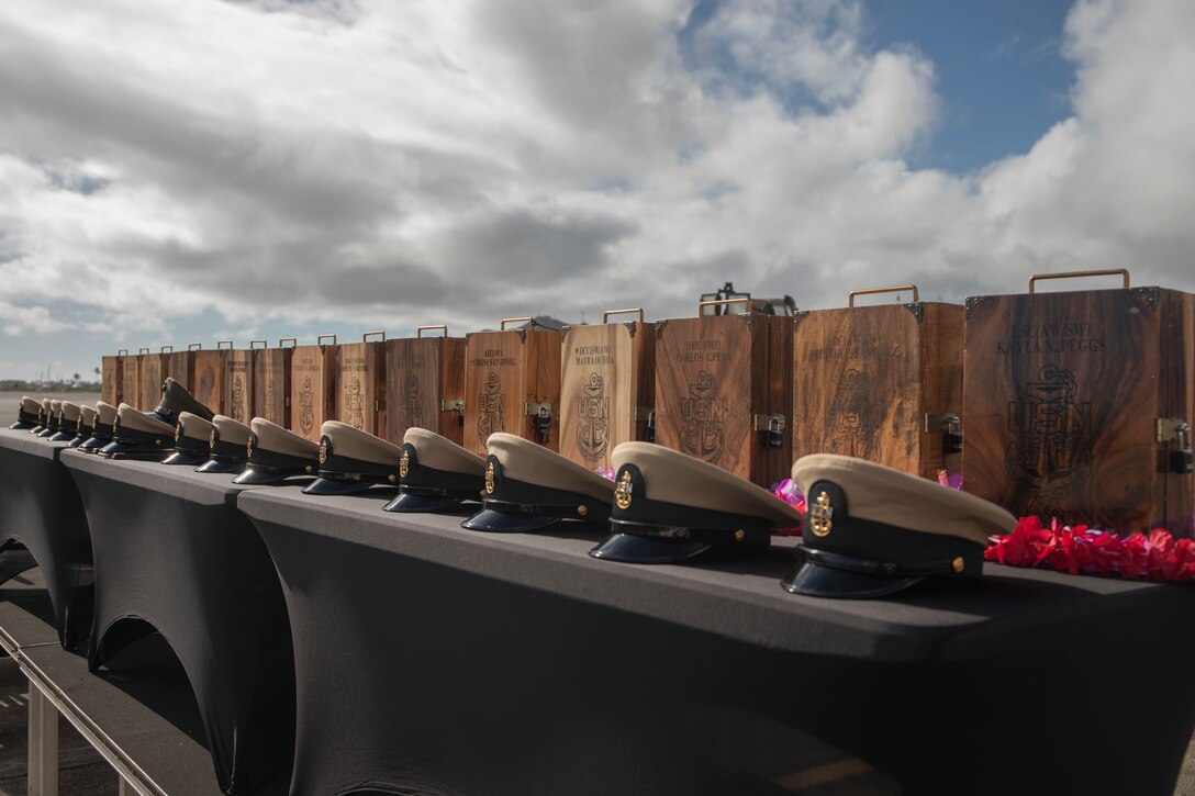 U.S. Navy combination caps and chief petty officer charge book vessels are displayed during the fiscal year 2024 Chief Petty Officer Class-130 Pinning Ceremony at Marine Corps Base Hawaii, Sept. 29, 2023. The pinning ceremony was the culmination of an intense six-week training period where the Navy's senior enlisted leaders introduced the chief petty officer selectees to a set of challenges designed to strengthen their leadership and mentoring abilities. 13 Sailors were pinned, and two Marines were awarded honorary chief petty officer at the ceremony. (U.S. Marine Corps photo by Sgt. Julian Elliott-Drouin)