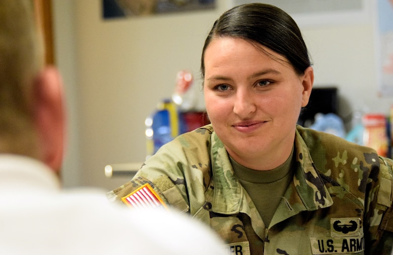 Uniformed female Army Soldier in uniform.