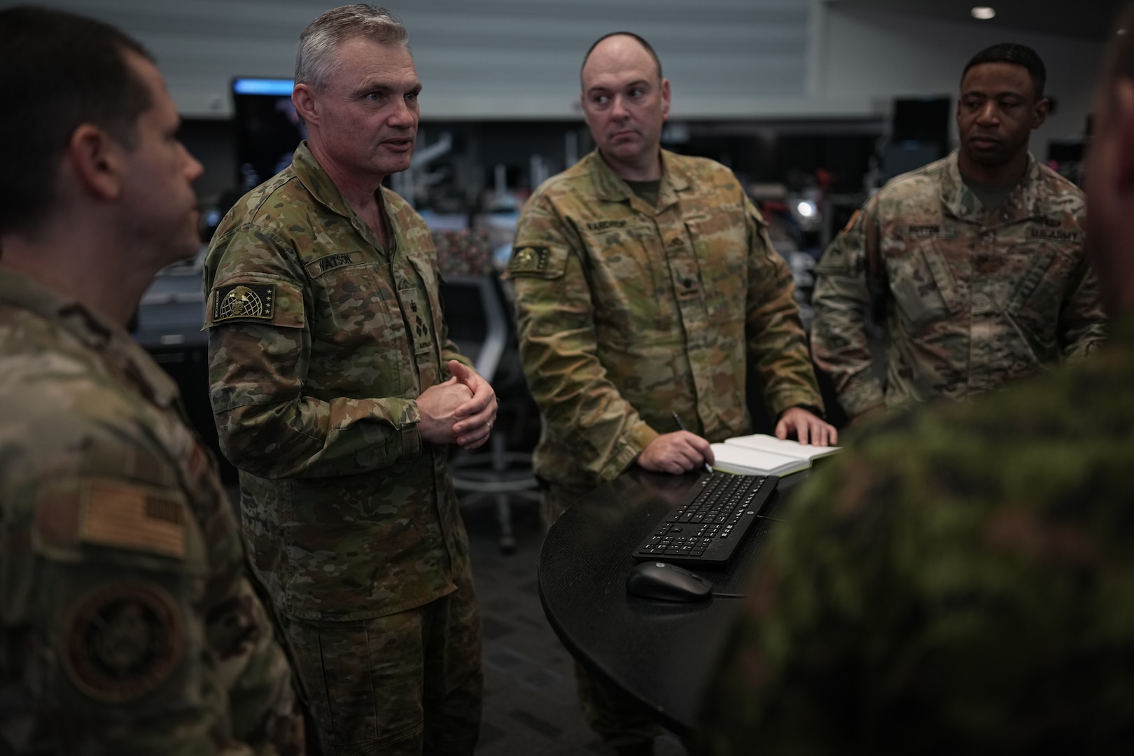 Joint Operation Center watch floor personnel at U.S. Cyber Command recap daily defensive cyber actions supporting an International Coordinated Cyber Security Activity.
