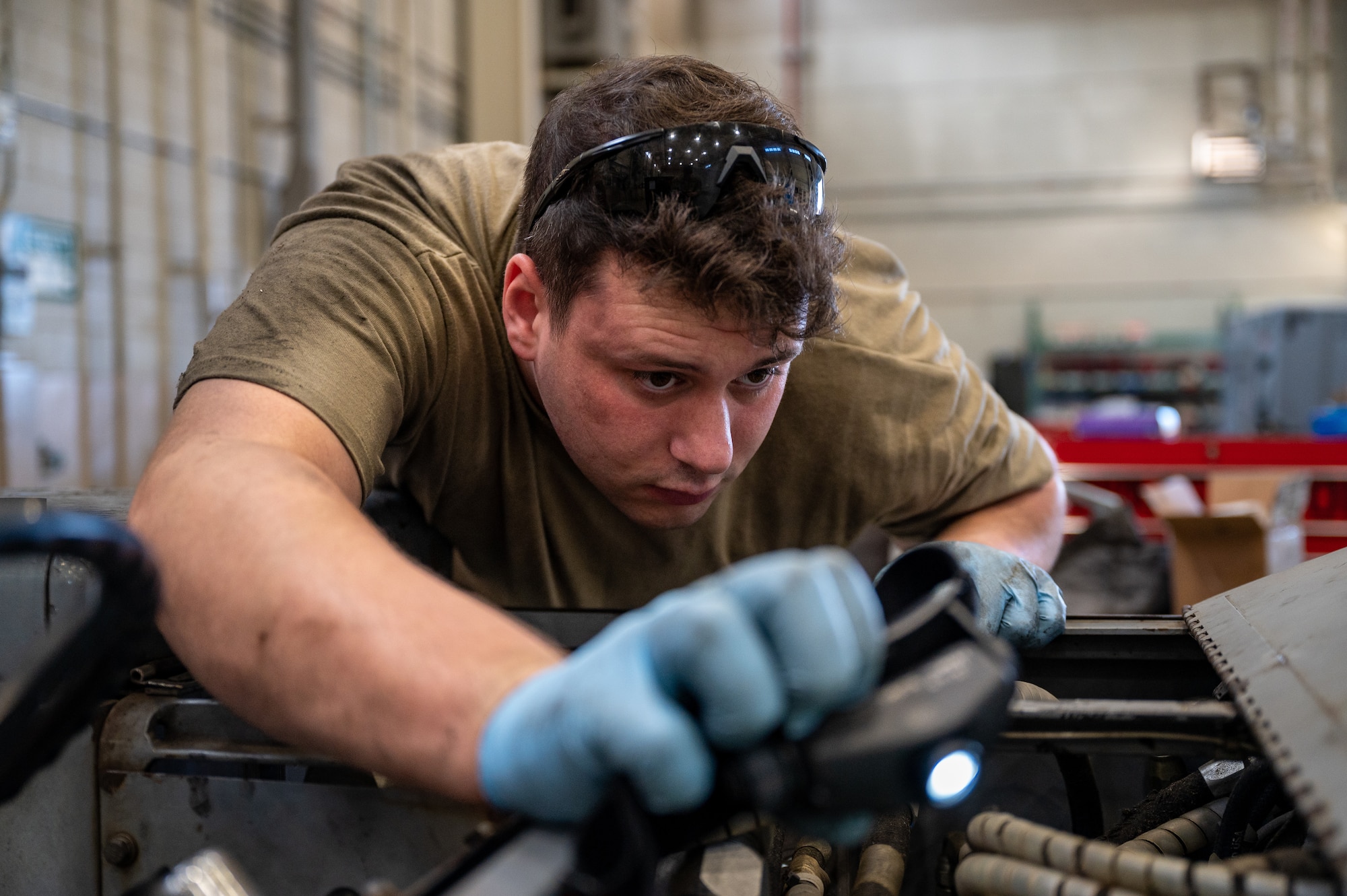 U.S. Air Force Staff Sgt. Christian Wilson, 51st Maintenance Squadron aerospace ground equipment craftsman, conducts a routine inspection on a bomb lift at Osan Air Base, Republic of Korea, Oct. 2, 2023. AGE technicians calibrate and maintain essential ground support equipment, ensuring optimal performance during aircraft operations. The bomb lifts maintained by AGE technicians are crucial to arming the A-10C Thunderbolt IIs and F-16 Fighting Falcons assigned to the 51st Fighter Wing, ensuring the ROK remains safe and combat-ready. (U.S. Air Force photo by Staff Sgt. Thomas Sjoberg)