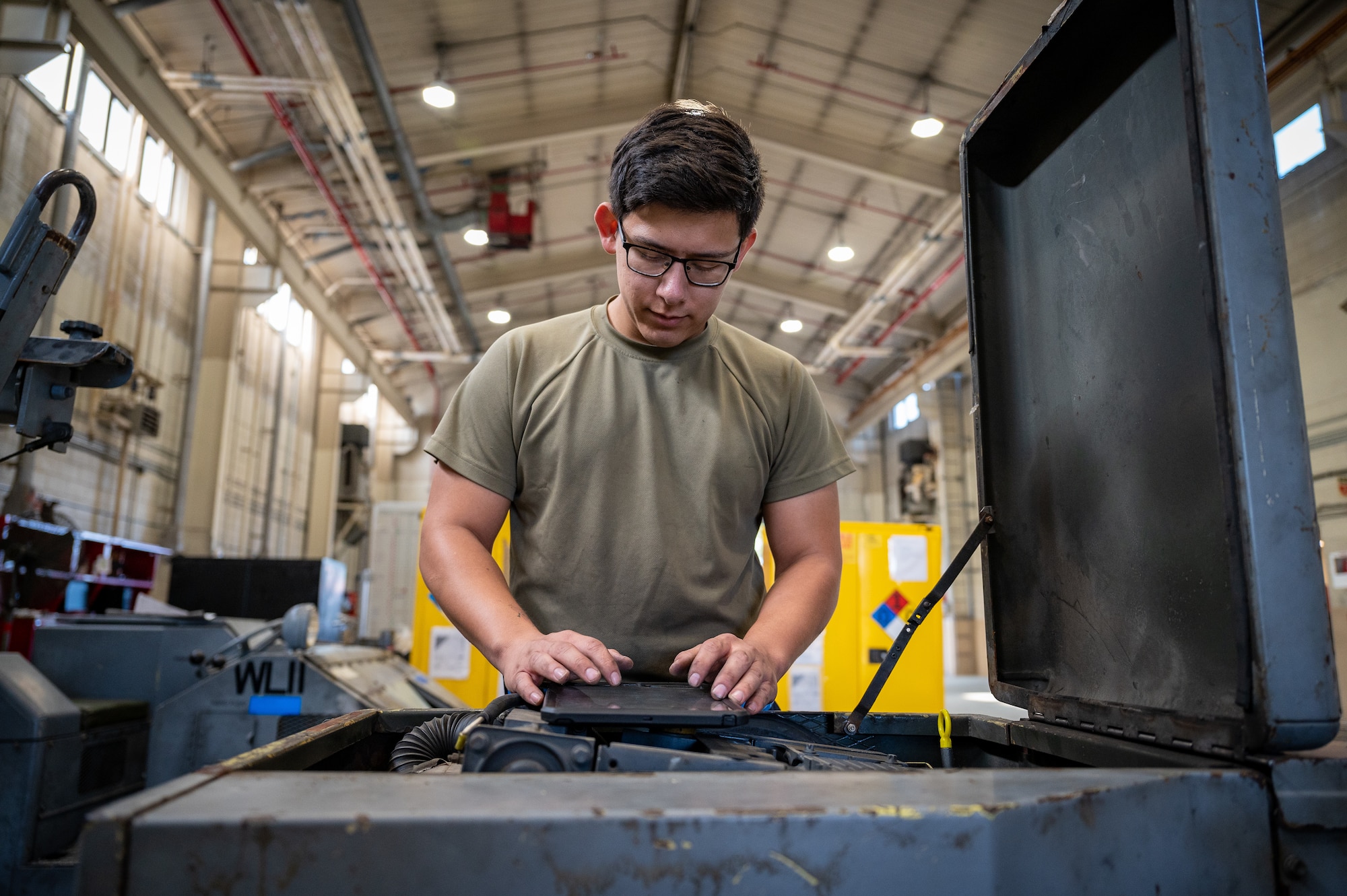 U.S. Air Force Senior Airman Jimi Hernandez, 51st Maintenance Squadron aerospace ground equipment journeyman, conducts a routine inspection on a bomb lift at Osan Air Base, Republic of Korea, Oct. 2, 2023. AGE technicians oversee the inspection, maintenance and repair of vital ground support equipment, crucial for the continued operation of the 51st Fighter Wing's aircraft. The bomb lifts maintained by AGE technicians are crucial to arming the A-10C Thunderbolt IIs and F-16 Fighting Falcons assigned to the 51st FW, ensuring the ROK remains safe and combat-ready. (U.S. Air Force photo by Staff Sgt. Thomas Sjoberg)