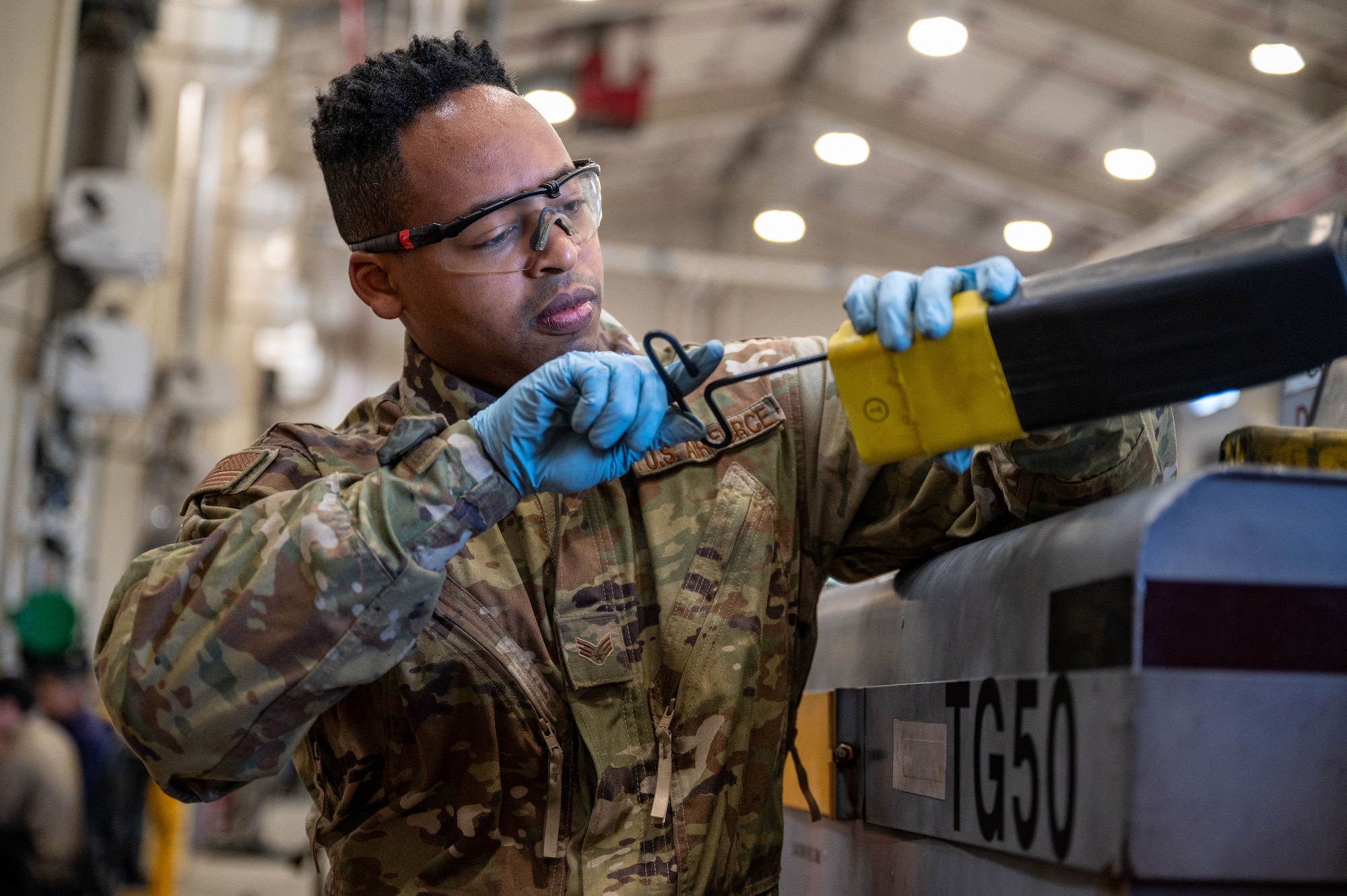 U.S. Air Force Senior Airman Dwalyn Starks, 51st Maintenance Squadron aerospace ground equipment journeyman, conducts maintenance on a diesel generator power cable at Osan Air Base, Republic of Korea, Oct. 2, 2023. AGE technicians play a pivotal role in safeguarding aircraft by providing reliable power supplies, hydraulic systems and other crucial support tools. (U.S. Air Force photo by Staff Sgt. Thomas Sjoberg)