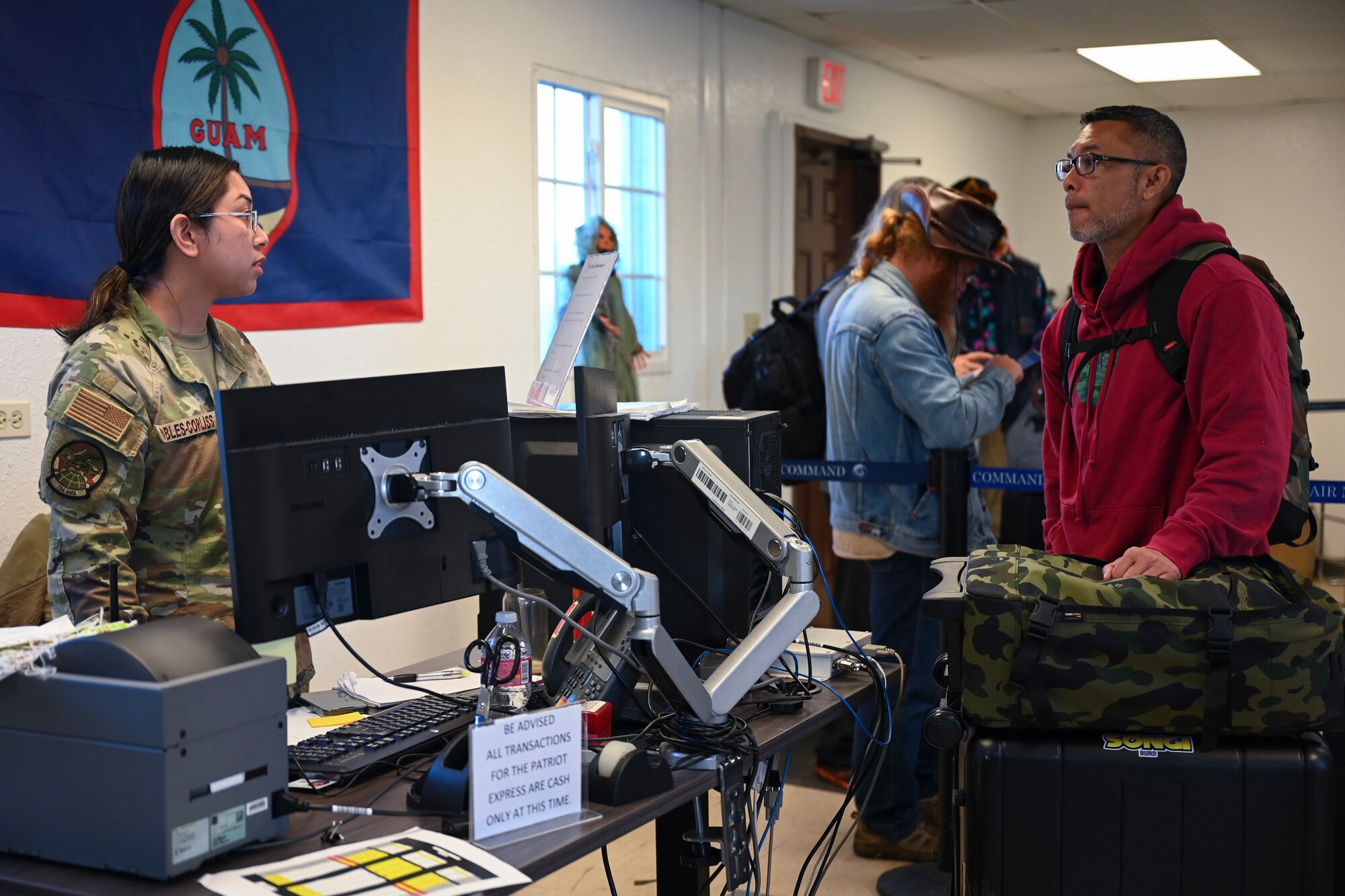 U.S. Air Force Airman 1st Class Julianna Robless-Croliss, 734th Air Mobility Squadron passenger service agent, assists customers with check-in at Andersen Air Force Base, Guam, Oct. 19, 2023.