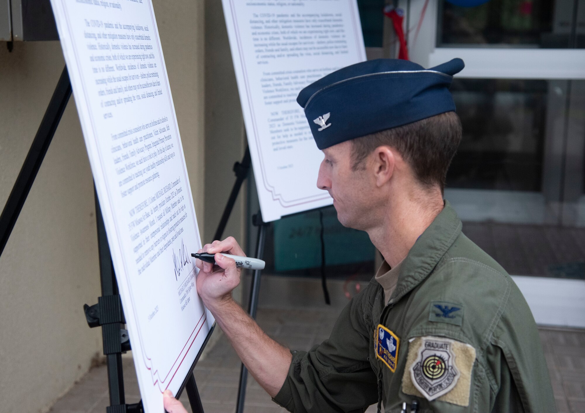 U.S. Air Force Col. Michael Richard, 35th Fighter Wing commander, signs a Domestic Violence Awareness Proclamation during a ceremony at Misawa Air Base, Japan, Oct. 5, 2023.