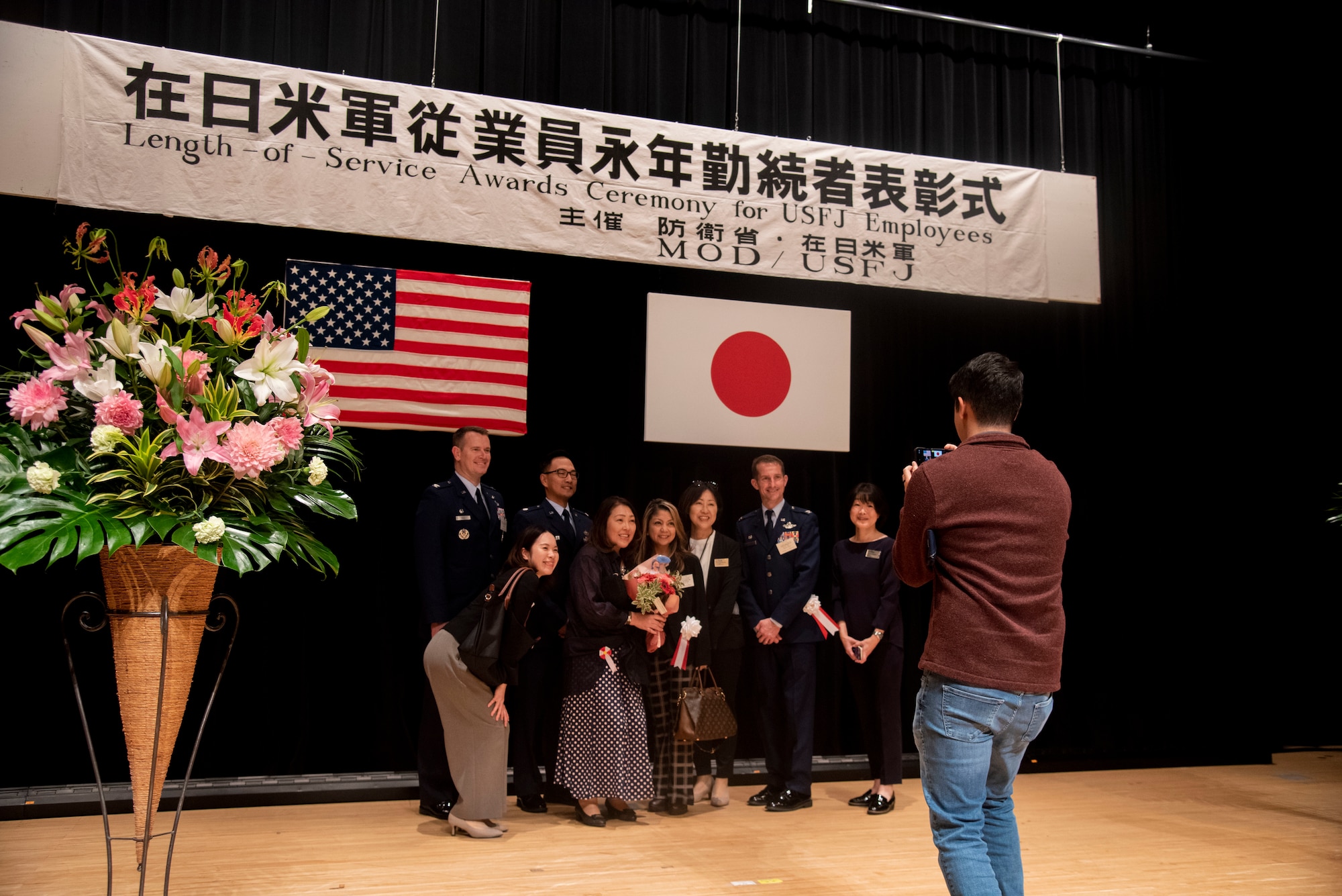 U.S. Air Force Col. Michael Richard, 35th Fighter Wing commander, stands with a recipient and their coworkers during a Length of Service Award Ceremony at Misawa City, Japan, Oct. 20, 2023.