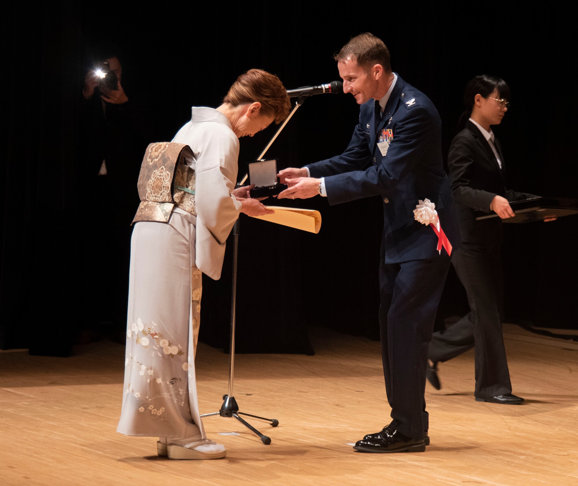 U.S. Air Force Col. Michael Richard, 35th Fighter Wing commander, awards a representative from the master labor contract and indirect hire agreement group during a Length of Service Award Ceremony at Misawa City, Japan, Oct. 20, 2023.