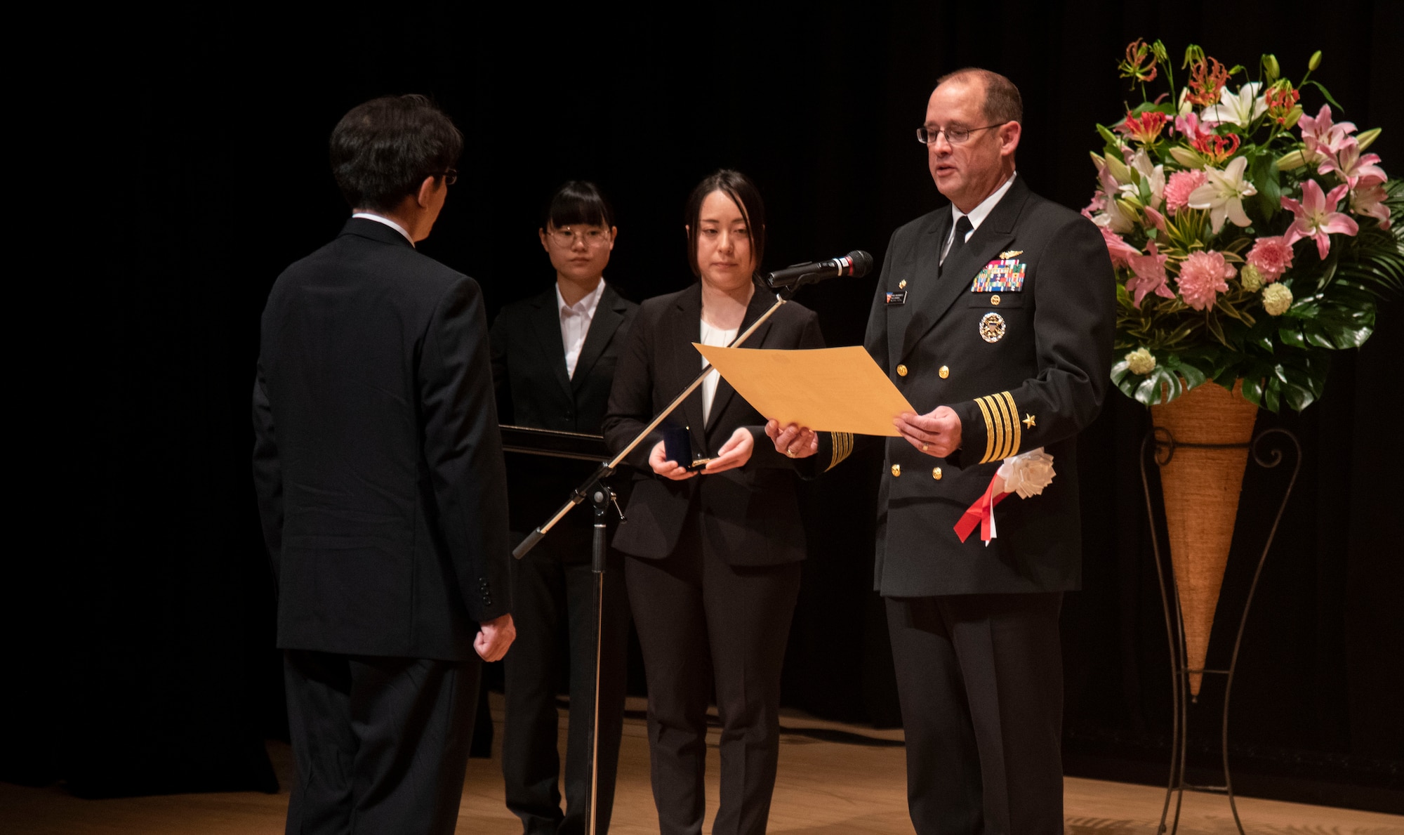 U.S. Navy Capt. Paul Hockran, Naval Air Facility Misawa commanding officer, awards a representative from the master labor contract and indirect hire agreement group during a Length of Service Award Ceremony at Misawa City, Japan, Oct. 20, 2023.