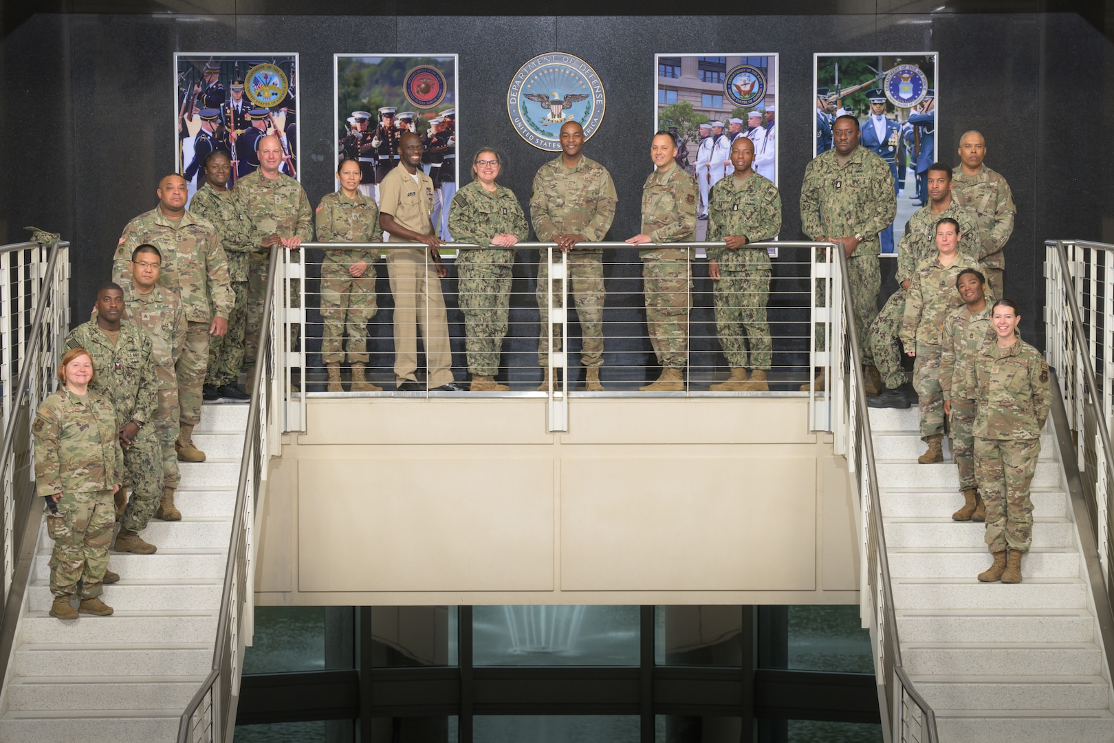 Reservists line a stairway railing centered around Command Chief Master Sergeant Alvin Dyer in a composed group portrait