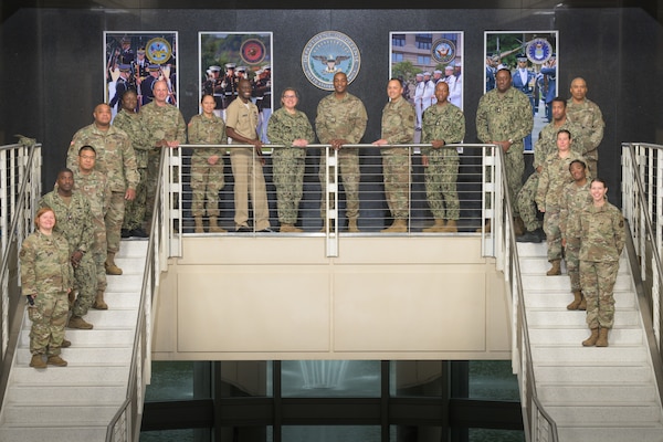 Reservists line a stairway railing centered around Command Chief Master Sergeant Alvin Dyer in a composed group portrait
