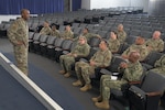 Command Chief Master Sergeant Alvin Dyer speaks to reservists seated in an auditorium