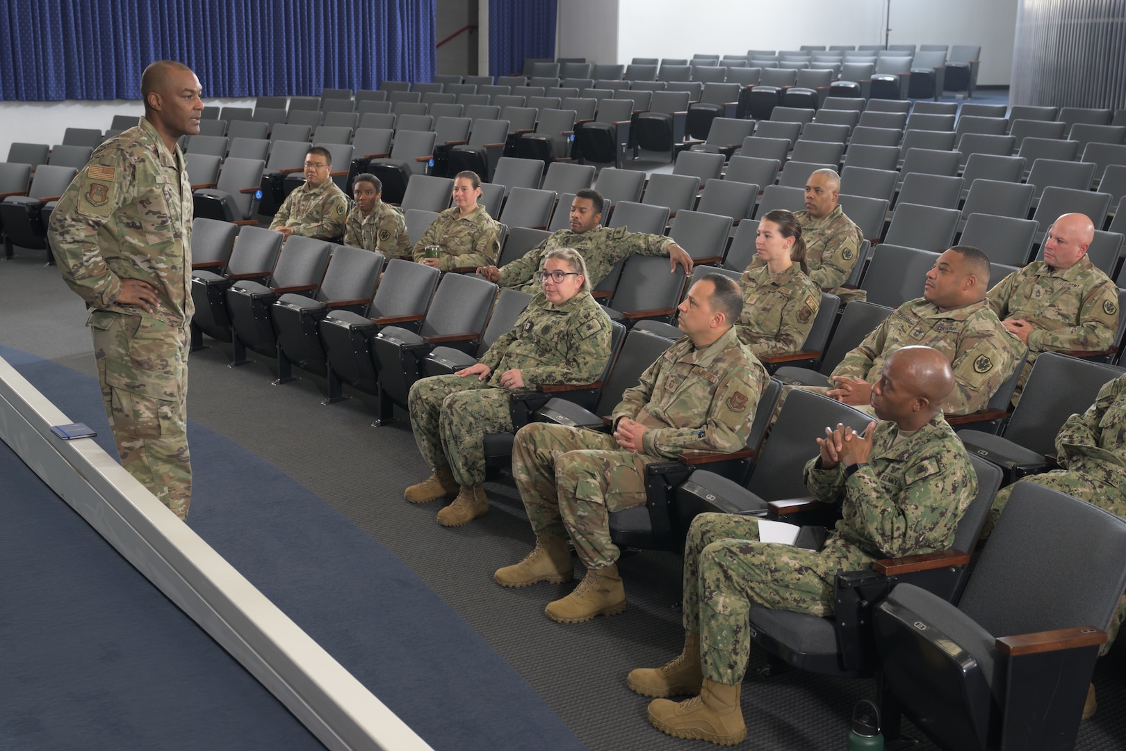 Command Chief Master Sergeant Alvin Dyer speaks to reservists seated in an auditorium