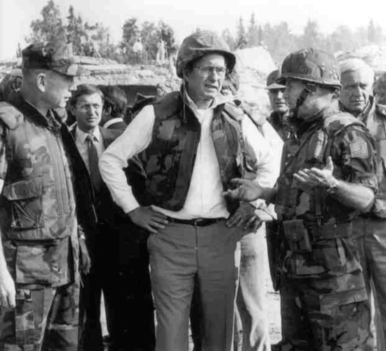 Men talk as they survey damage around them.