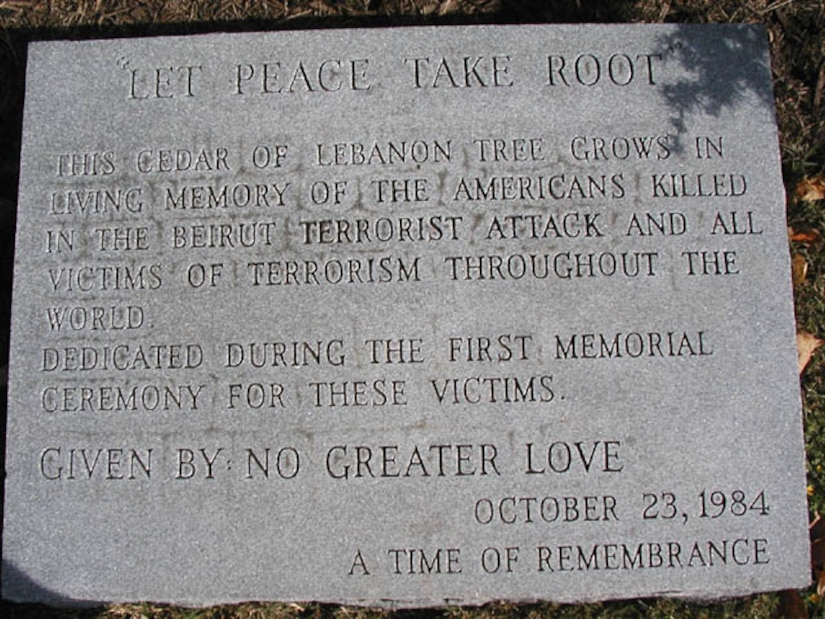 A cemetery marker commemorates lives lost by service members.