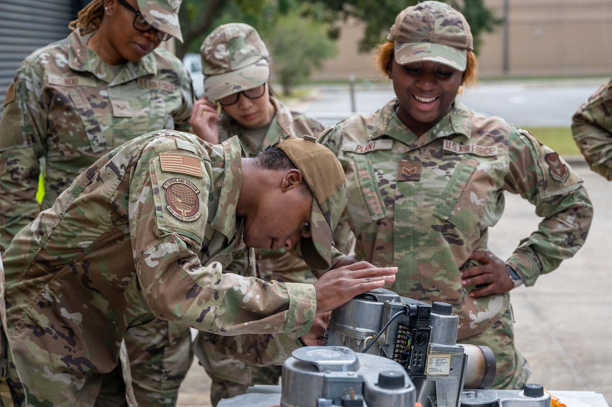 Airman replaces an air intake on a Babington burner.