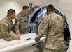 Three biomedical equipment specialists, or 68As, participating in the Army’s medical maintenance Training with Industry program conduct an inspection of a computed tomography, or CT, machine during on-the-job training Oct. 23, 2023. From left, the Soldiers pictured include Sgt. Erick Rodriguez, Staff Sgt. Konnor Grimshaw and Sgt. D’Angelo Brown. The TWI program serves to develop a group of Soldiers experienced in higher level managerial techniques and who understand the relationship of their industry as it relates to specific Army functions. (Courtesy Betsey Meyer)