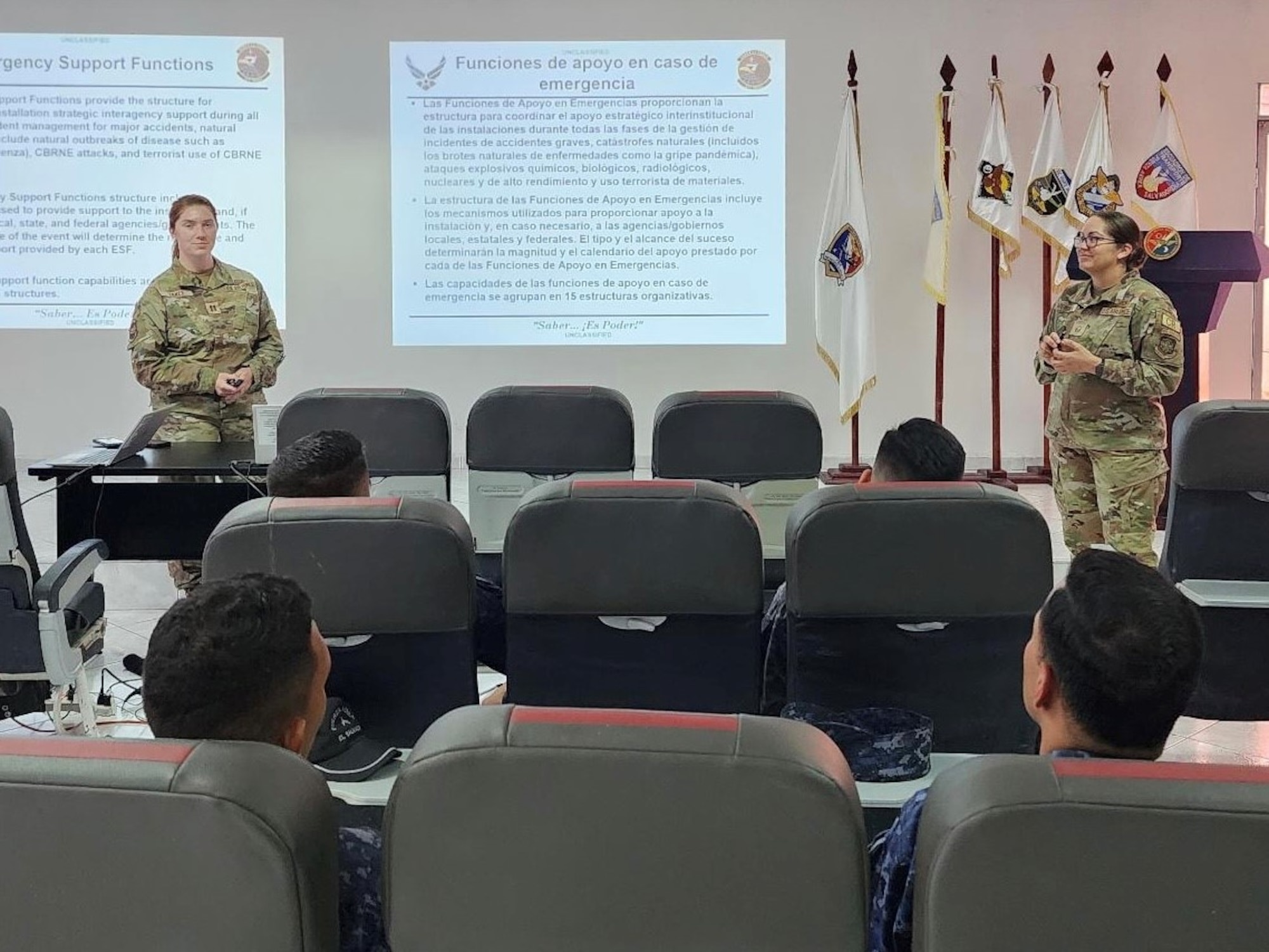 U.S. Air Force Capt. Kiara Vance and Master Sgt. Ana Mendiola, 571 Mobility Support Advisory Squadron air advisors stationed at Travis Air Force Base, Californiia, brief on Emergency Management concepts to members of the Fuerza Aérea Salvadoreña (FAS) during El Salvador Mobile Training Team 23-22, Aug. 28, 2023, Ilopango International Airport, San Salvador.