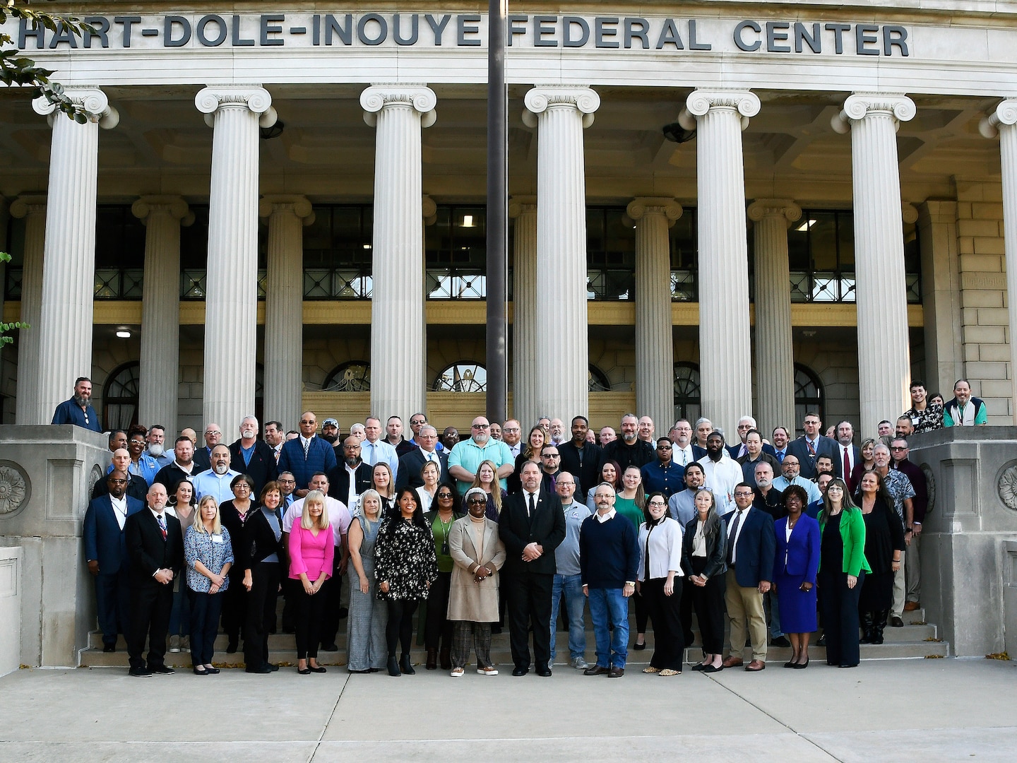 group shot of people on stairs in front of columns