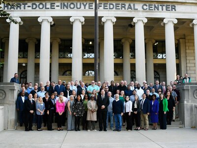 group shot of people on stairs in front of columns