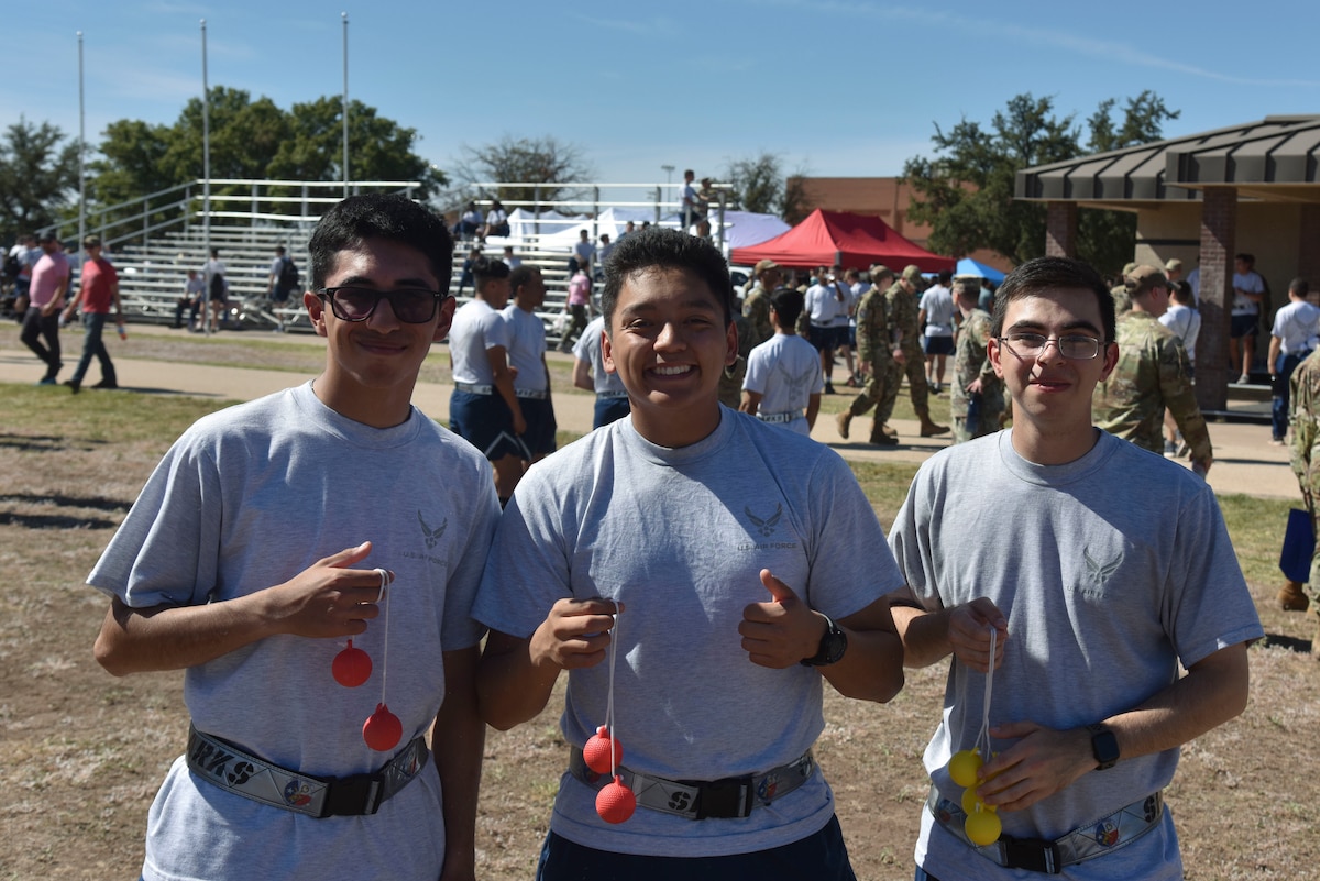U.S. Air Force Airman Basic Jochum Kaj, Airmen 1st Class Christopher Martinez and Anguiano Bryan, 316th Training Squadron students, pose for a photo during the Diversity, Equity, Inclusion, and Accessibility: We Belong event at the parade field, Goodfellow Air Force Base, Texas, Oct. 20, 2023. The focus of DEIA Day was to highlight the significance of recognizing and embracing the diverse range of personalities and backgrounds within the military. (U.S. Air Force photo by Airman James Salellas)